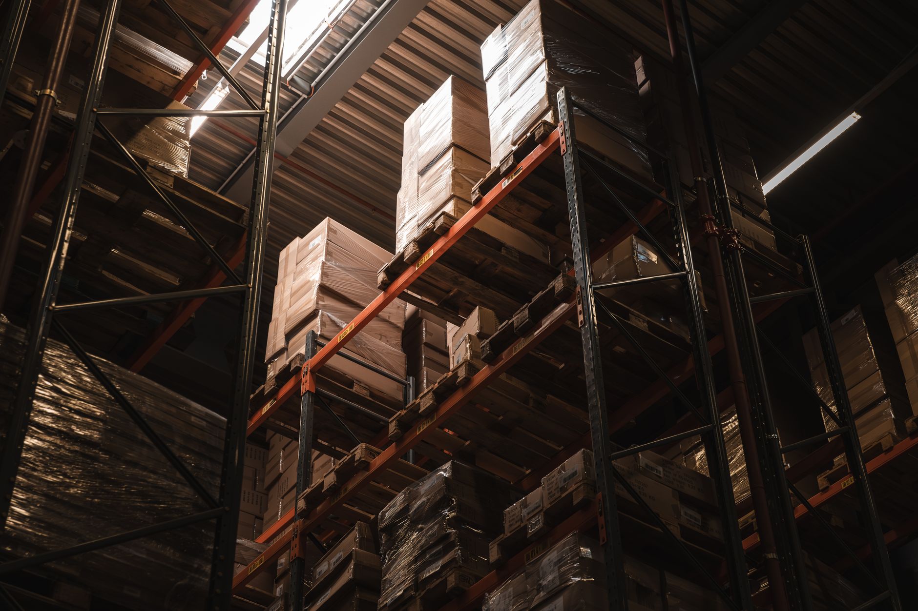 interior of a large-scale server farm with rows of illuminated GPU racks stretching into the distance, shot from a low wide angle