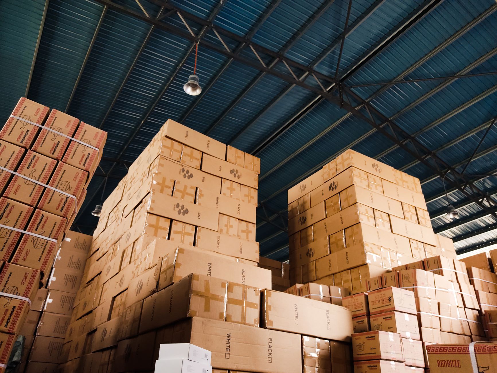 rows of pharmaceutical storage units inside a climate-controlled distribution warehouse with ambient blue lighting