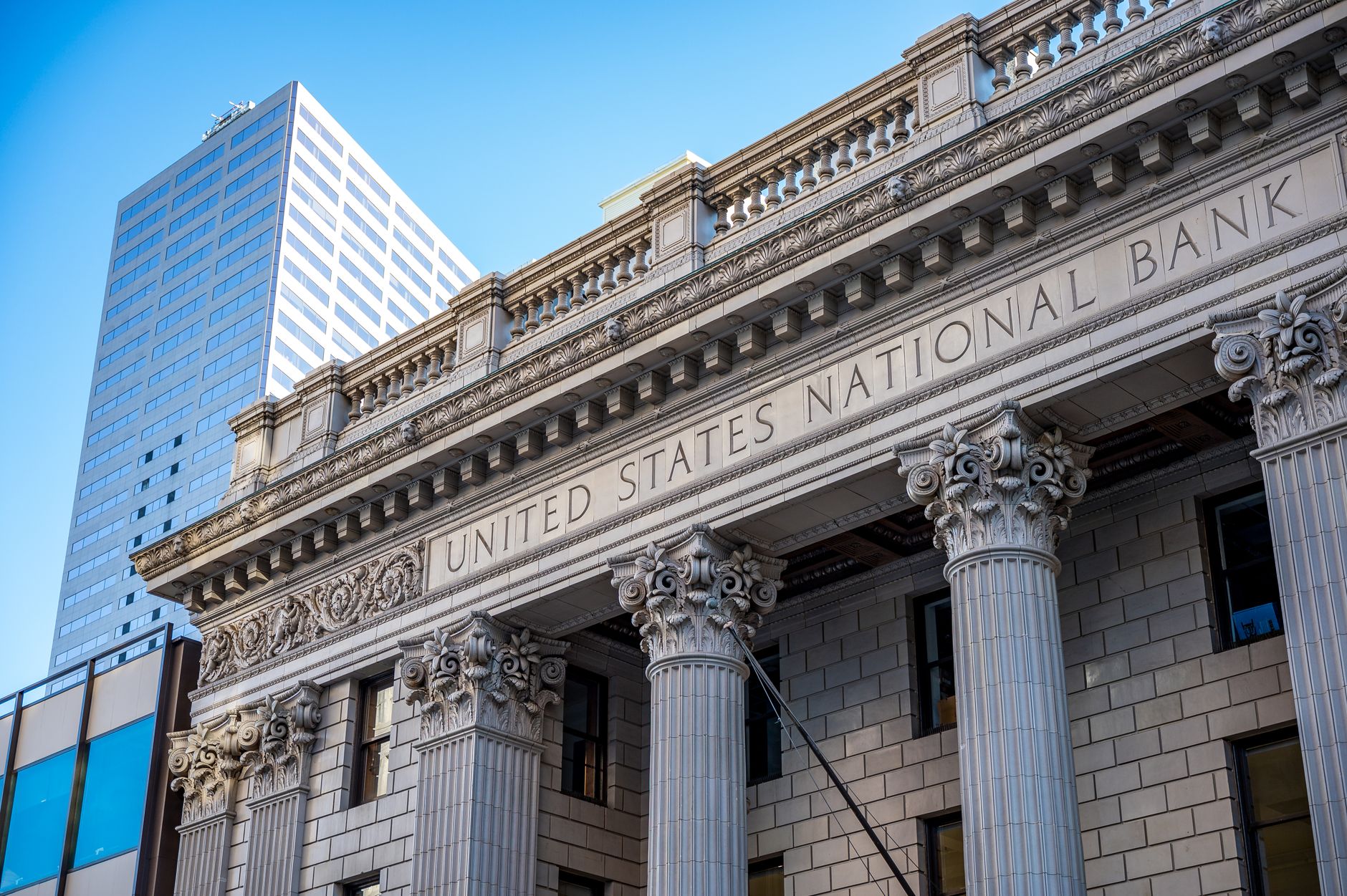exterior of a Federal Reserve regional bank building on an overcast afternoon, with an empty stone plaza in the foreground