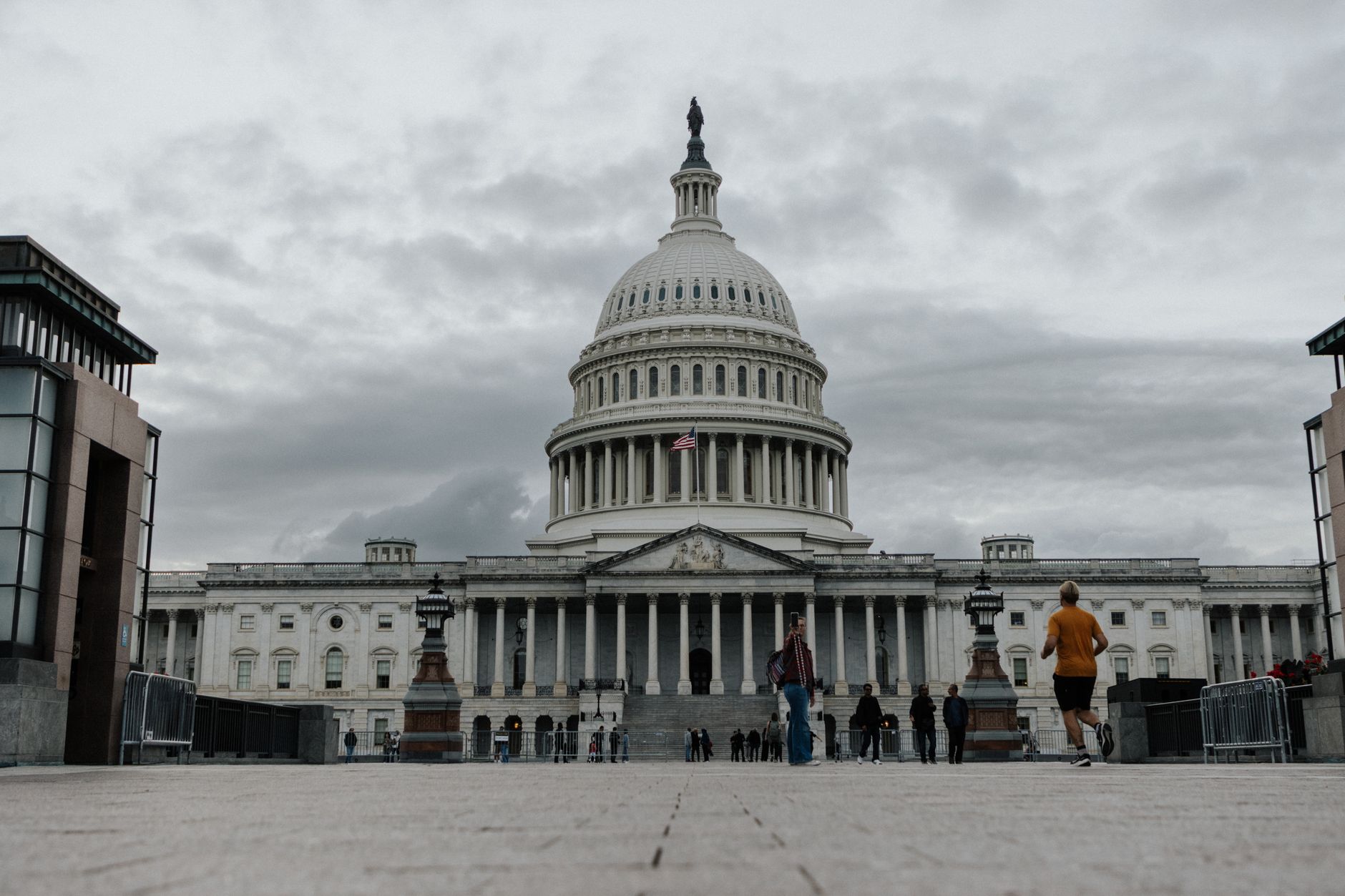 exterior view of the Federal Reserve building in Washington D.C. with an empty plaza and overcast sky overhead