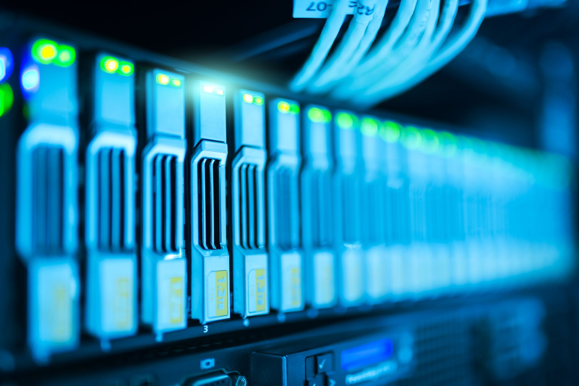 rows of computer servers inside a modern data center facility with blue ambient lighting and cable management racks