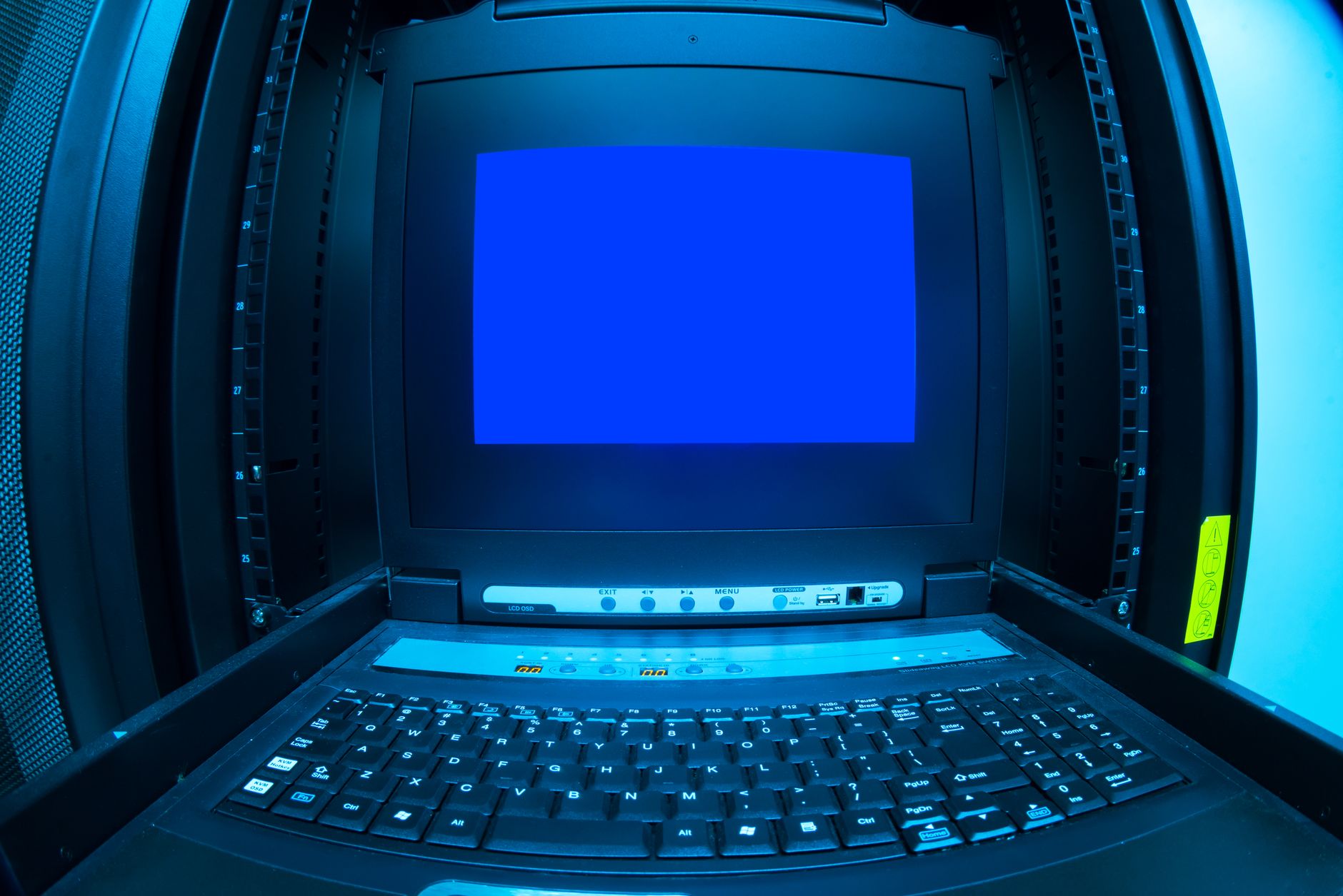 interior of a modern cybersecurity operations center with glowing monitors displaying network traffic visualizations, no people in foreground