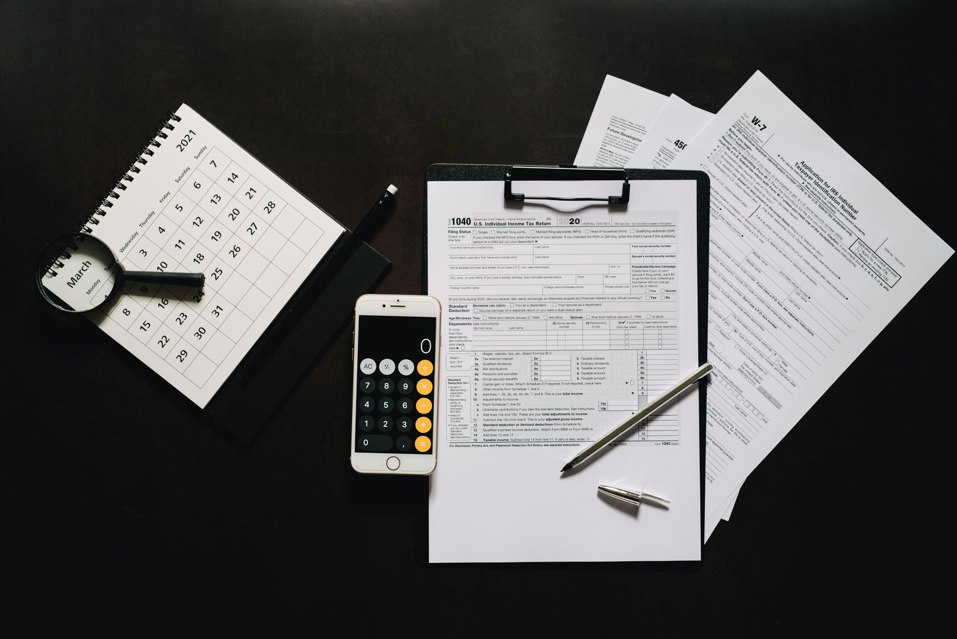close-up of Indian government bond certificates and financial documents laid out on a wooden desk beside a calculator