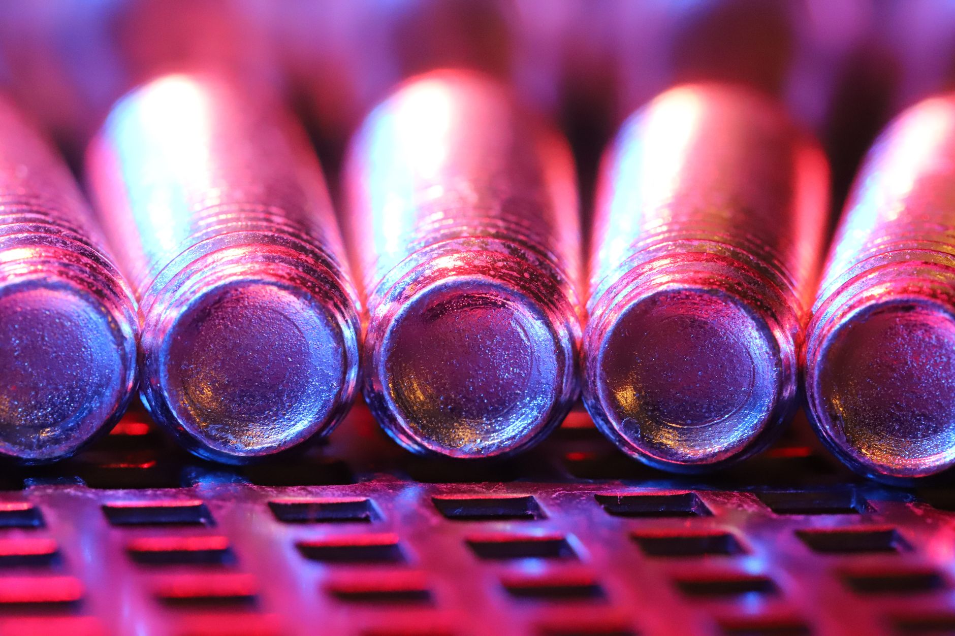 close-up of a cryogenic quantum processor suspended inside a cylindrical vacuum chamber with metallic wiring visible around it