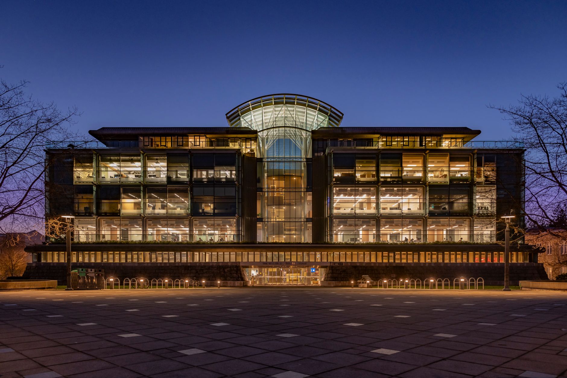 exterior of a large modern corporate technology campus with glass-fronted buildings and manicured grounds under a clear afternoon sky
