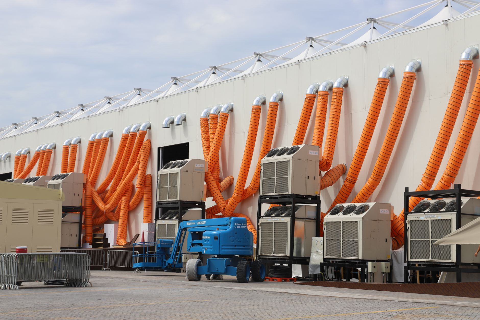 exterior of a modern data center facility at night, server cooling units and ventilation stacks visible along the building's side wall