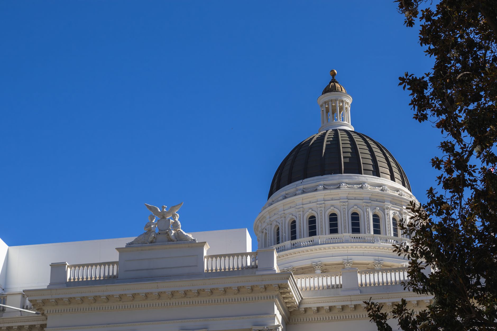 exterior view of the U.S. Capitol building on a clear day, wide shot showing the dome and surrounding grounds