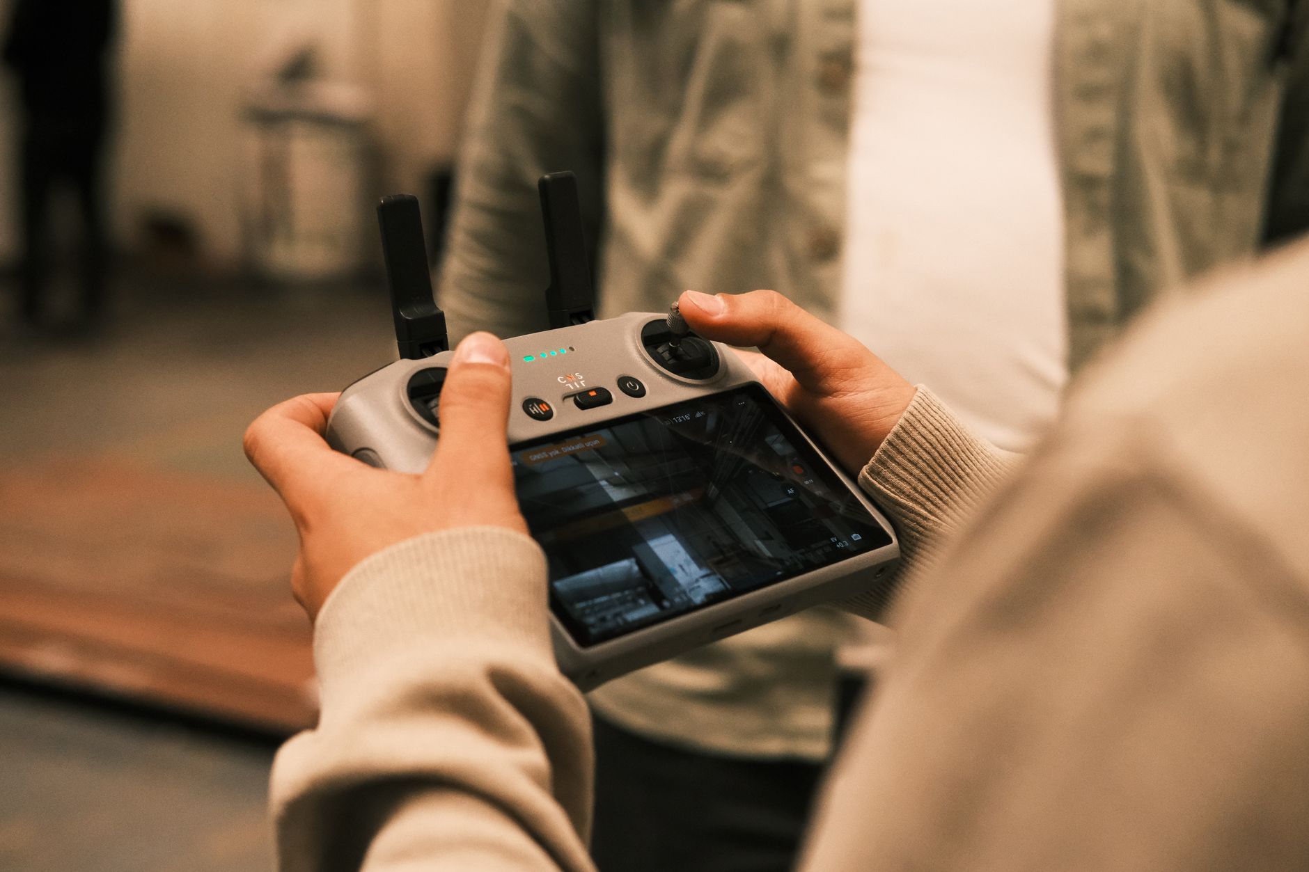close-up of a drone autonomy control interface displayed on an industrial-grade ruggedized tablet resting on a field operations table outdoors