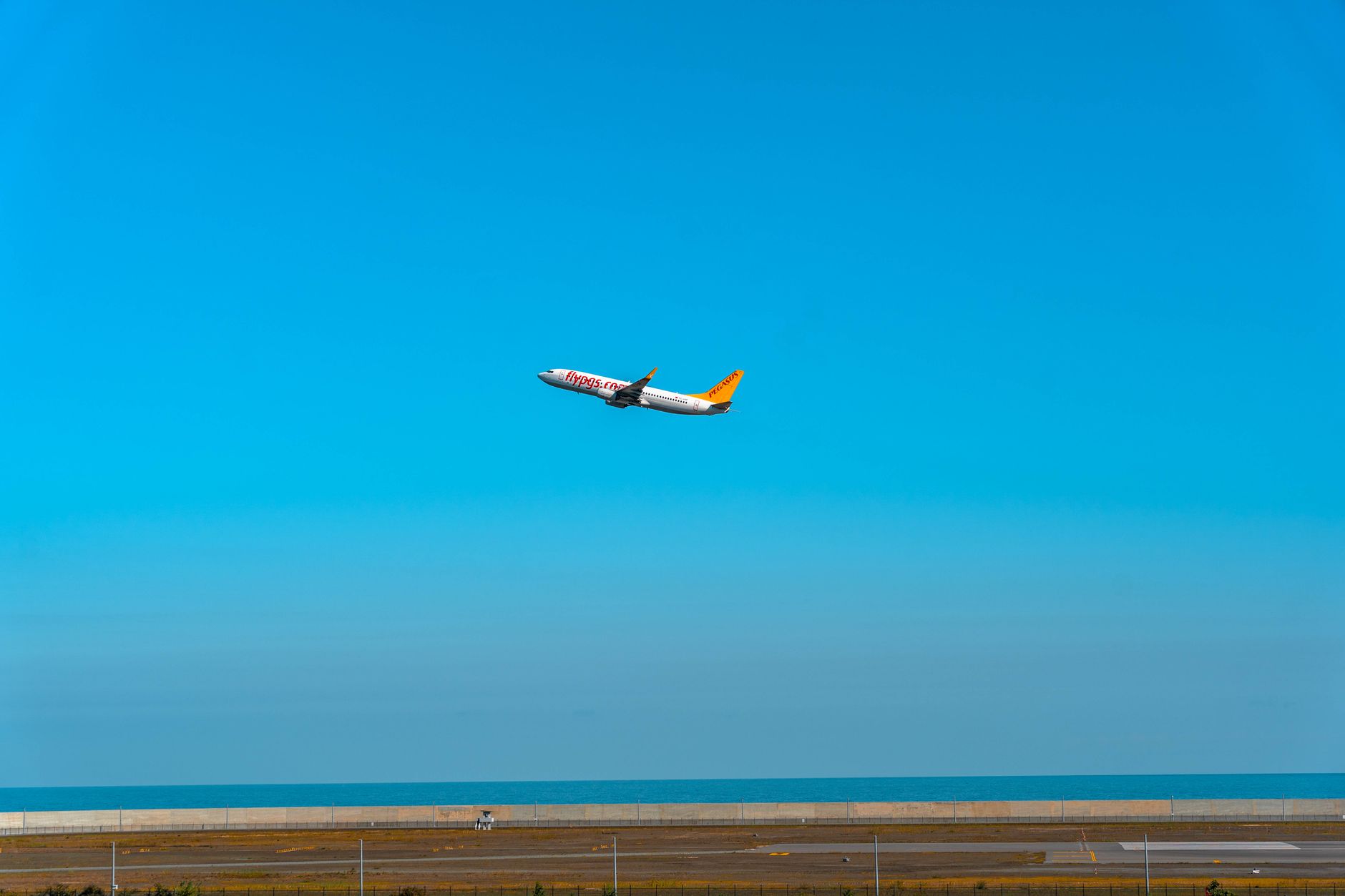 aerial view of Ben Gurion International Airport terminal apron with aircraft parked at gates under a clear midday sky