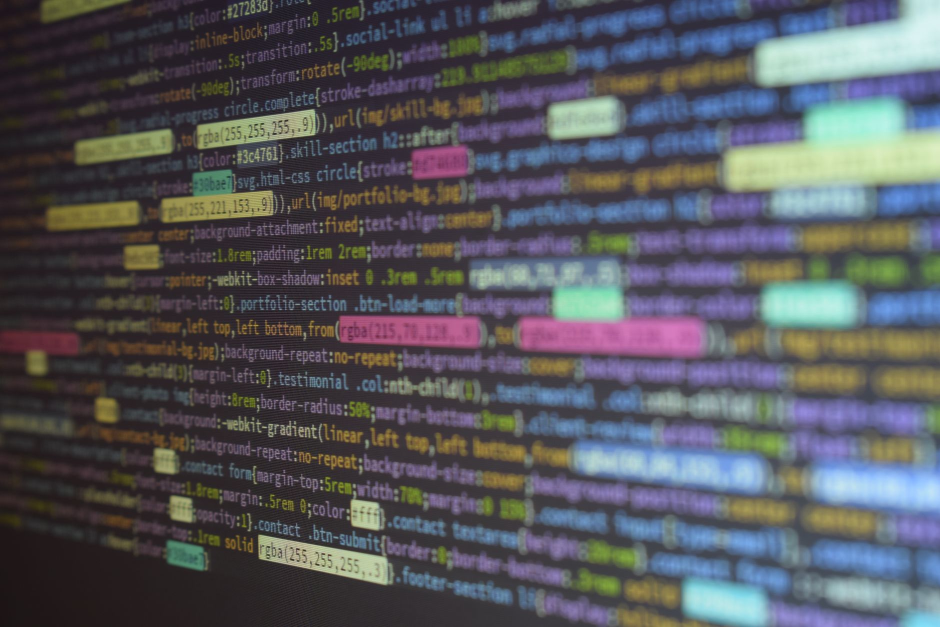 close-up of a computer monitor displaying lines of code and error logs in a dimly lit software testing lab