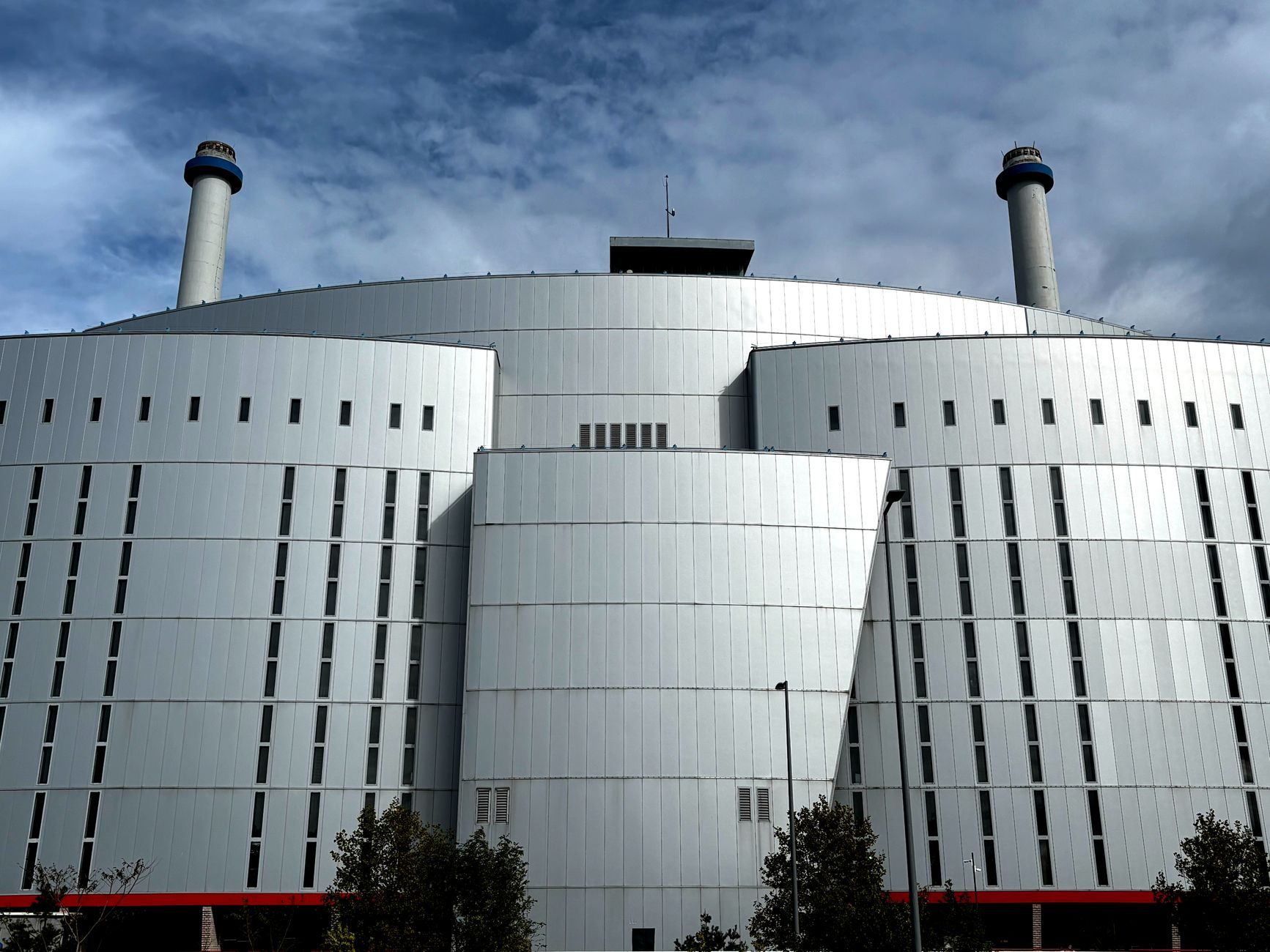 exterior of a semiconductor fabrication facility with large industrial ventilation units and clean-room infrastructure visible along the building facade