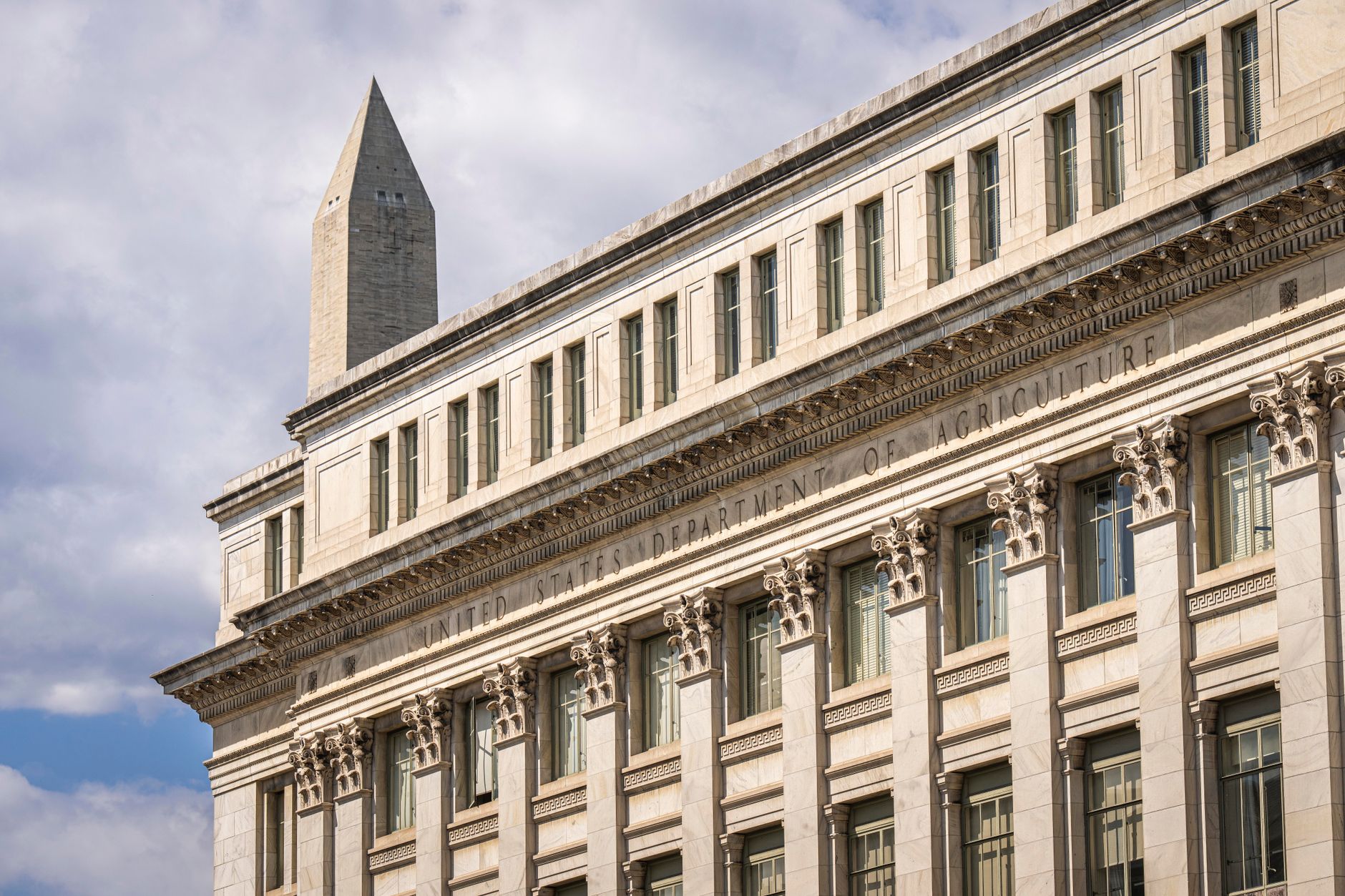 exterior of the Canadian Department of Finance building in Ottawa on an overcast day, stone facade and national flag visible