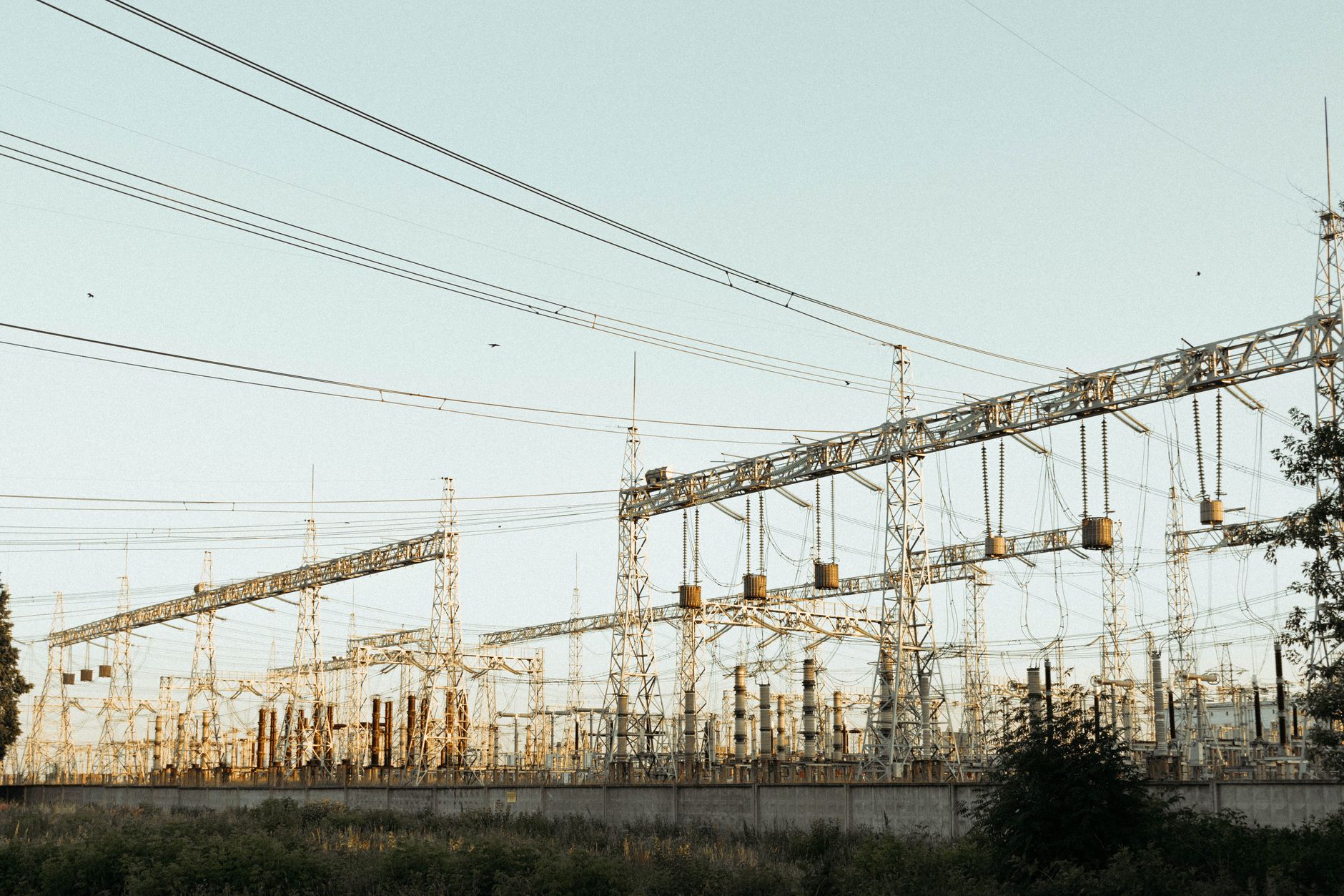 exterior of a semiconductor fabrication facility at dusk with clean room ventilation towers and soft overhead lighting