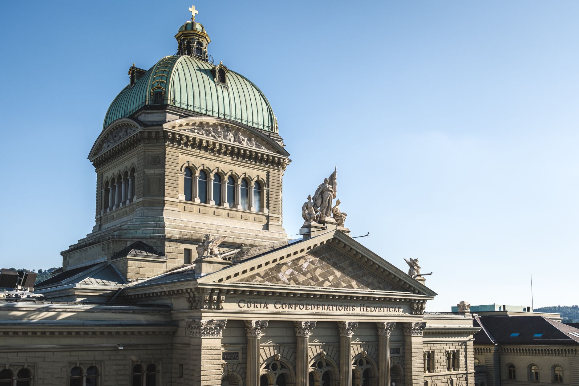exterior of the Swiss National Bank headquarters in Bern, a stone neoclassical building on a quiet morning street