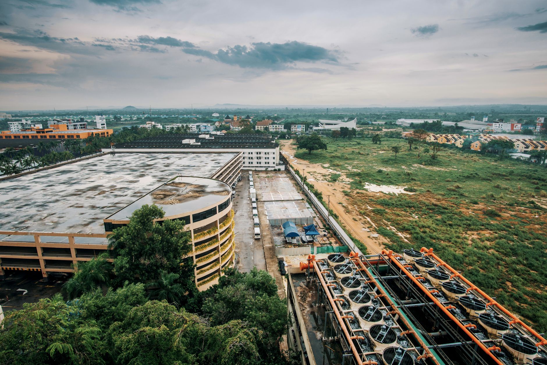 aerial view of a mid-sized electronics manufacturing plant with white rooftop panels and loading docks in an Israeli industrial zone at midday