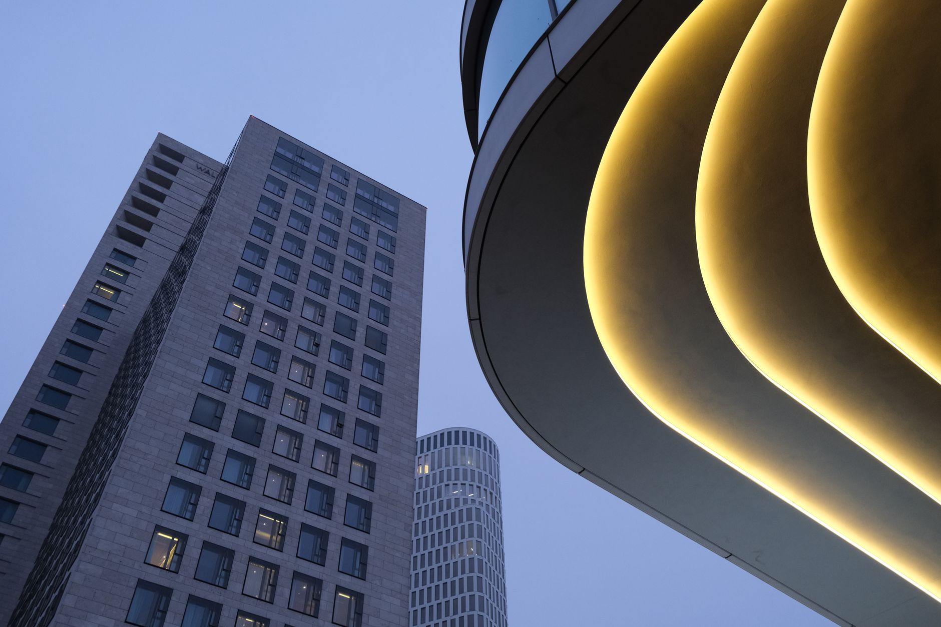 exterior of a cryptocurrency exchange data center at dusk, with server cooling units visible along the building facade