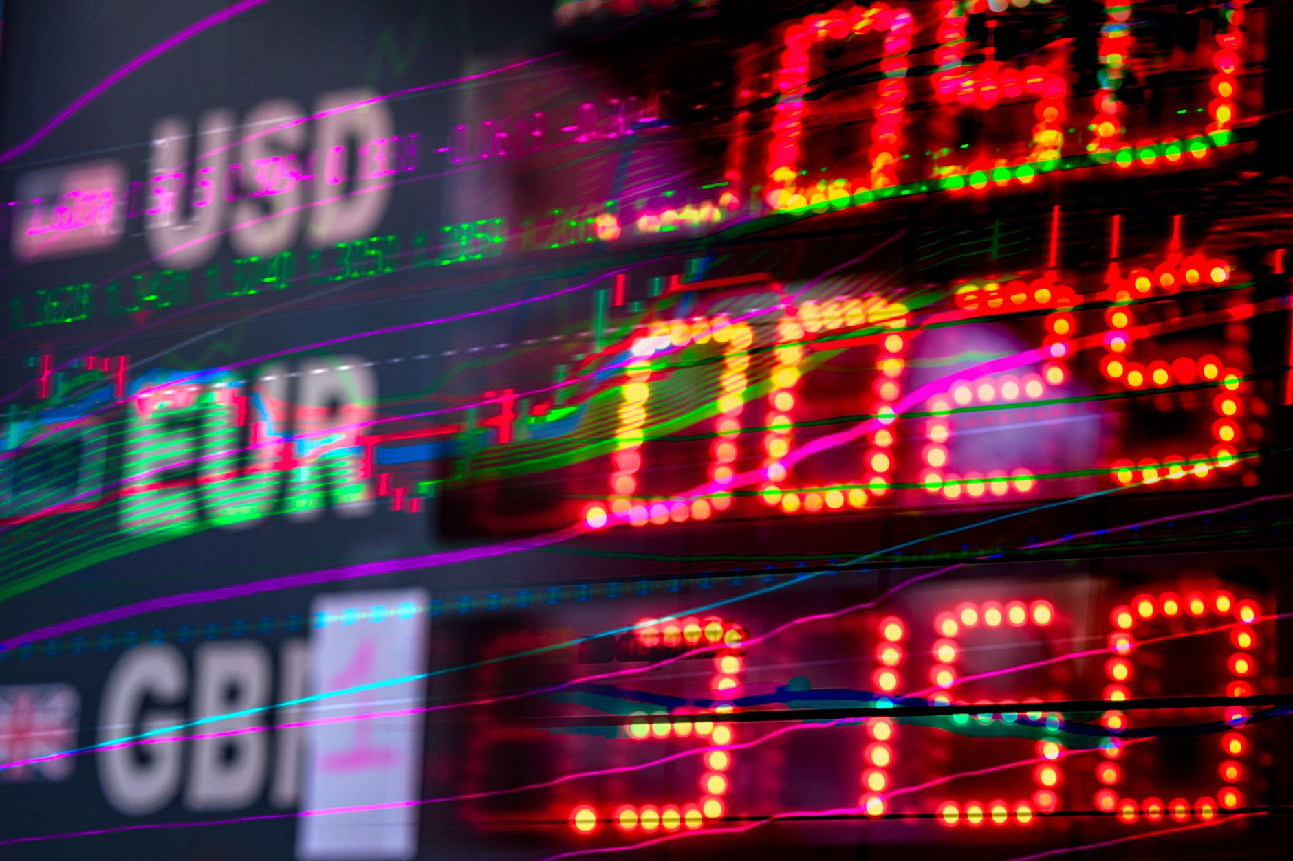 rows of trading terminals in an empty financial dealing room, screens displaying bond yield curves and interest rate probability charts