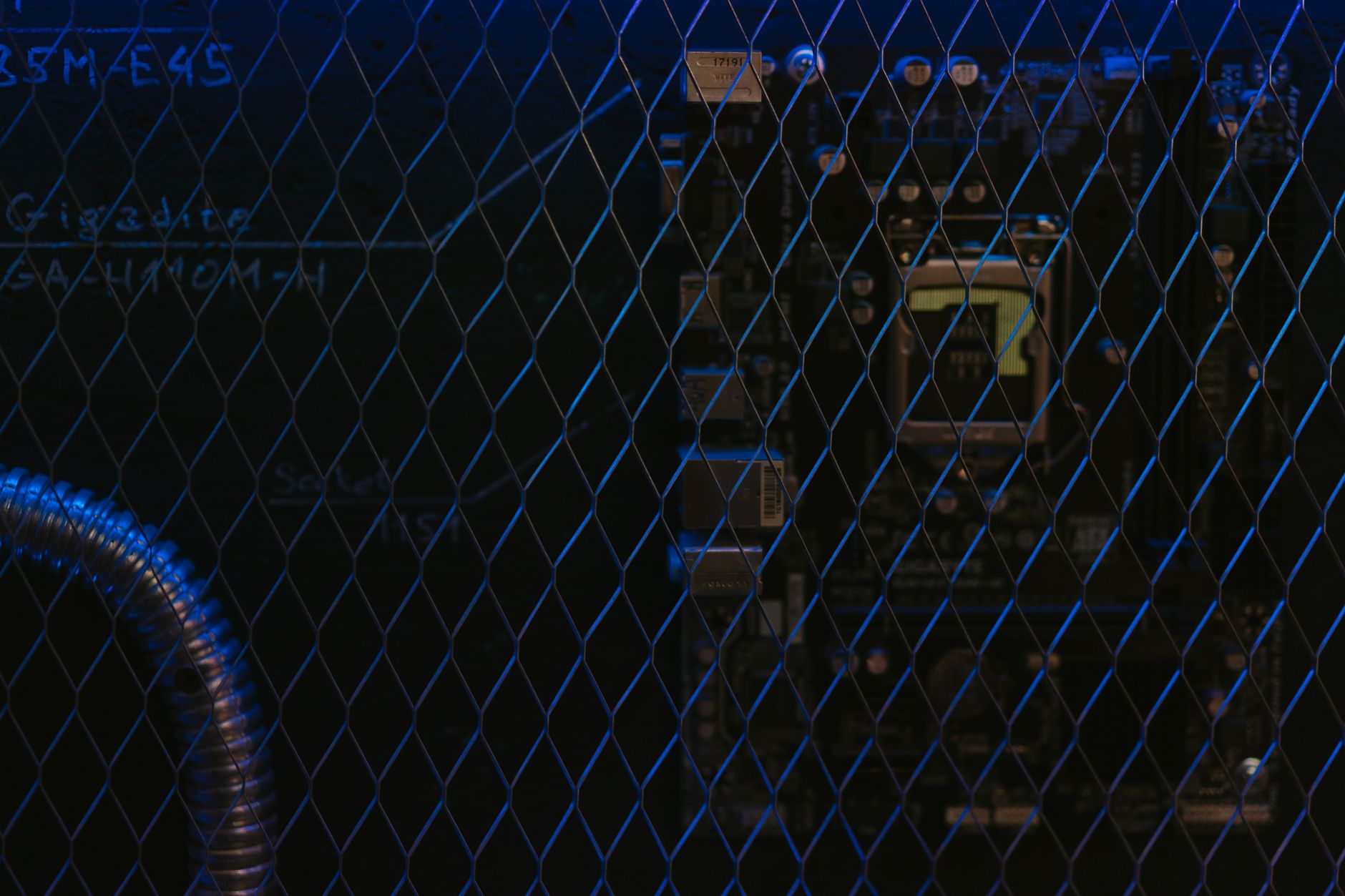 interior of a quantum computing laboratory with cryogenic cooling chambers mounted in rows under low ambient lighting, metallic tubing and control electronics visible throughout