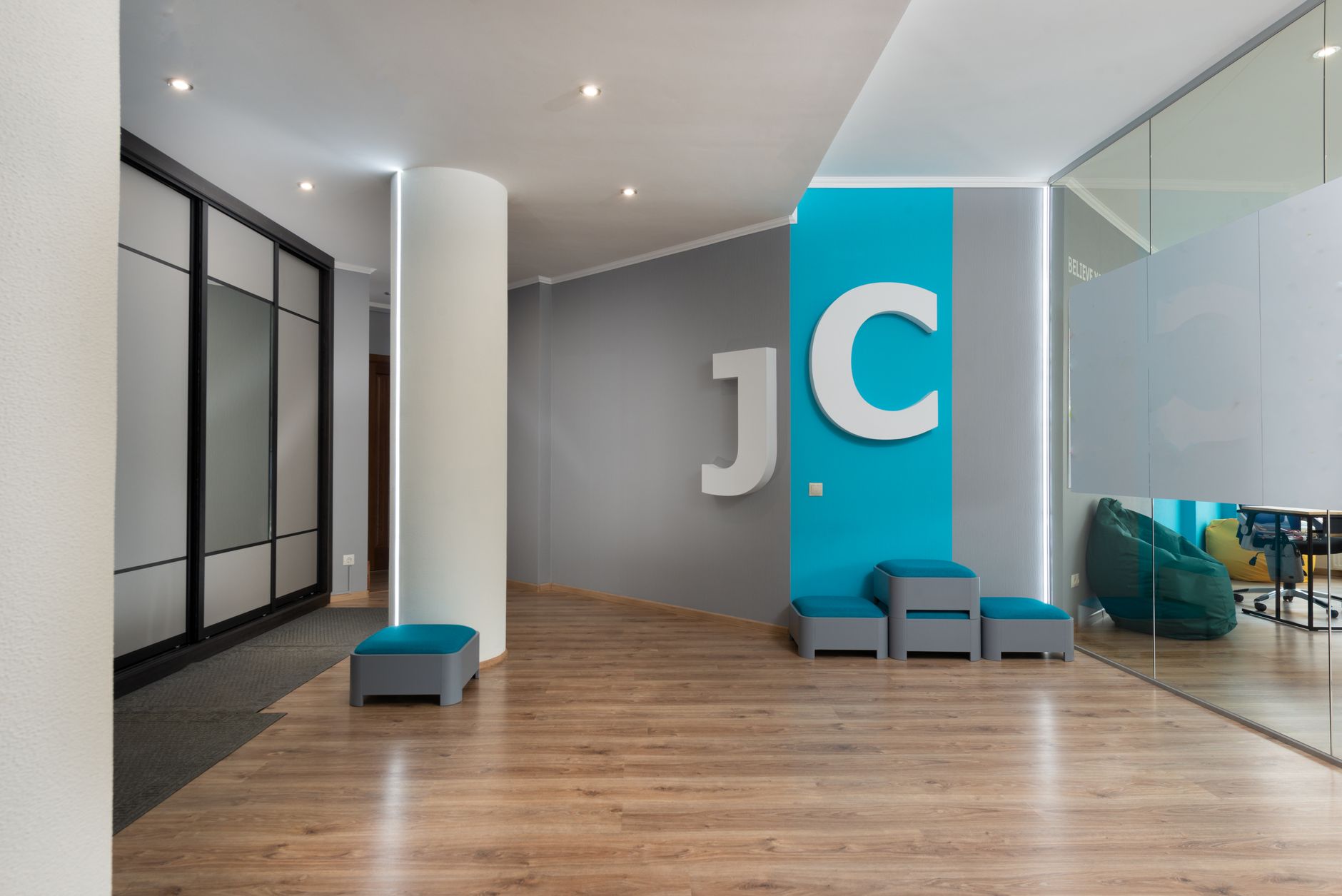 interior of a modern Tel Aviv tech office building lobby with glass walls and rows of workstations visible in the background