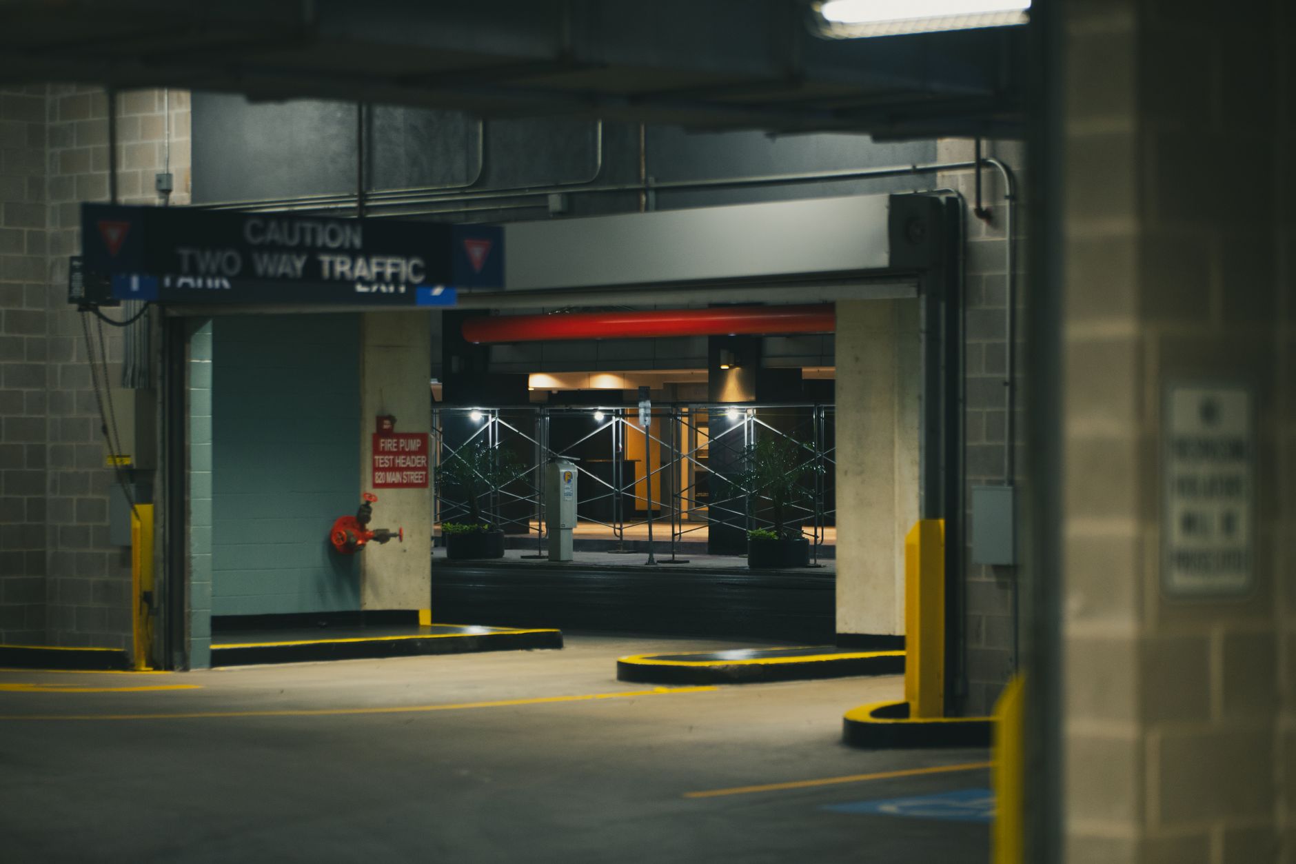 a state unemployment office exterior with a weathered sign above glass doors and a mostly empty parking lot in late afternoon light