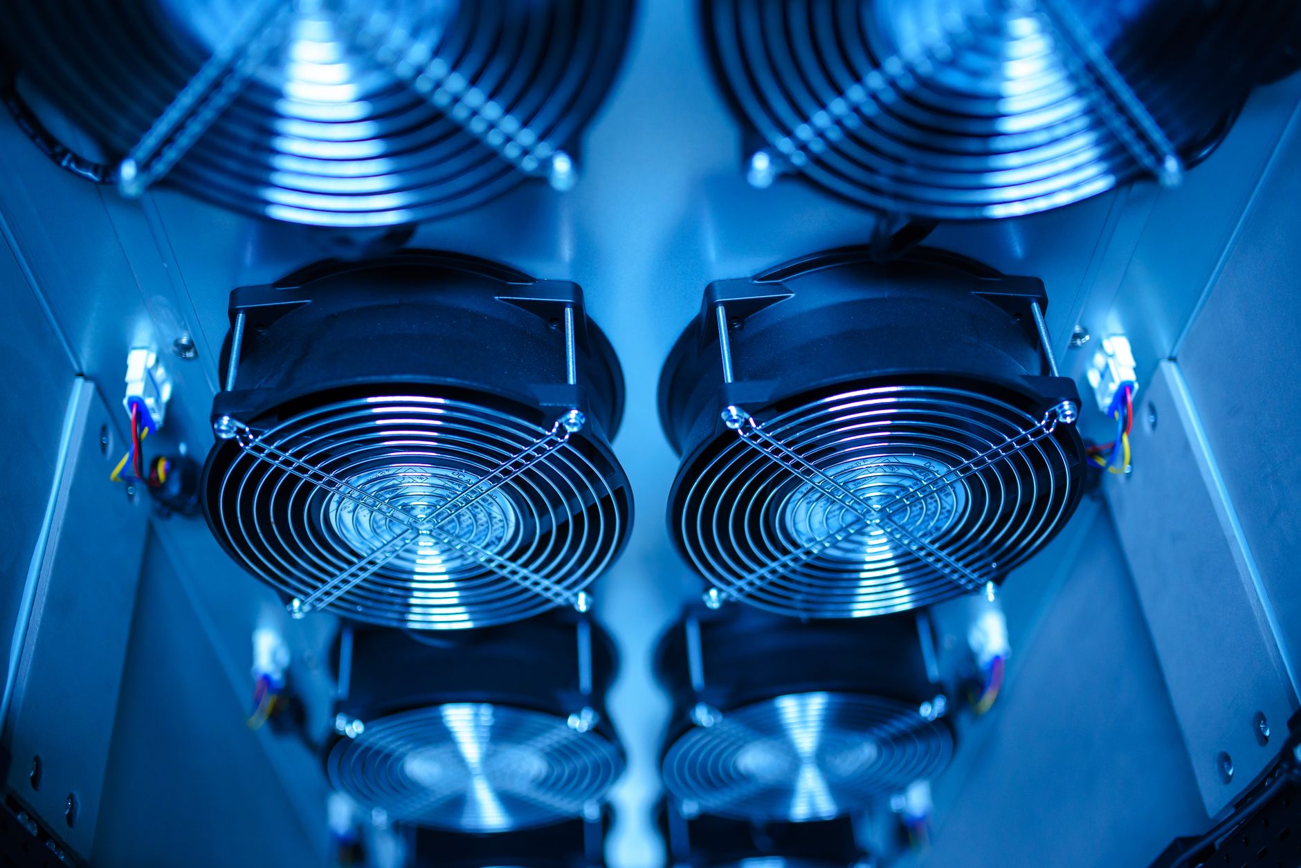 close-up of server rack lighting inside a modern data center facility, with blue indicator lights running along densely packed blade servers