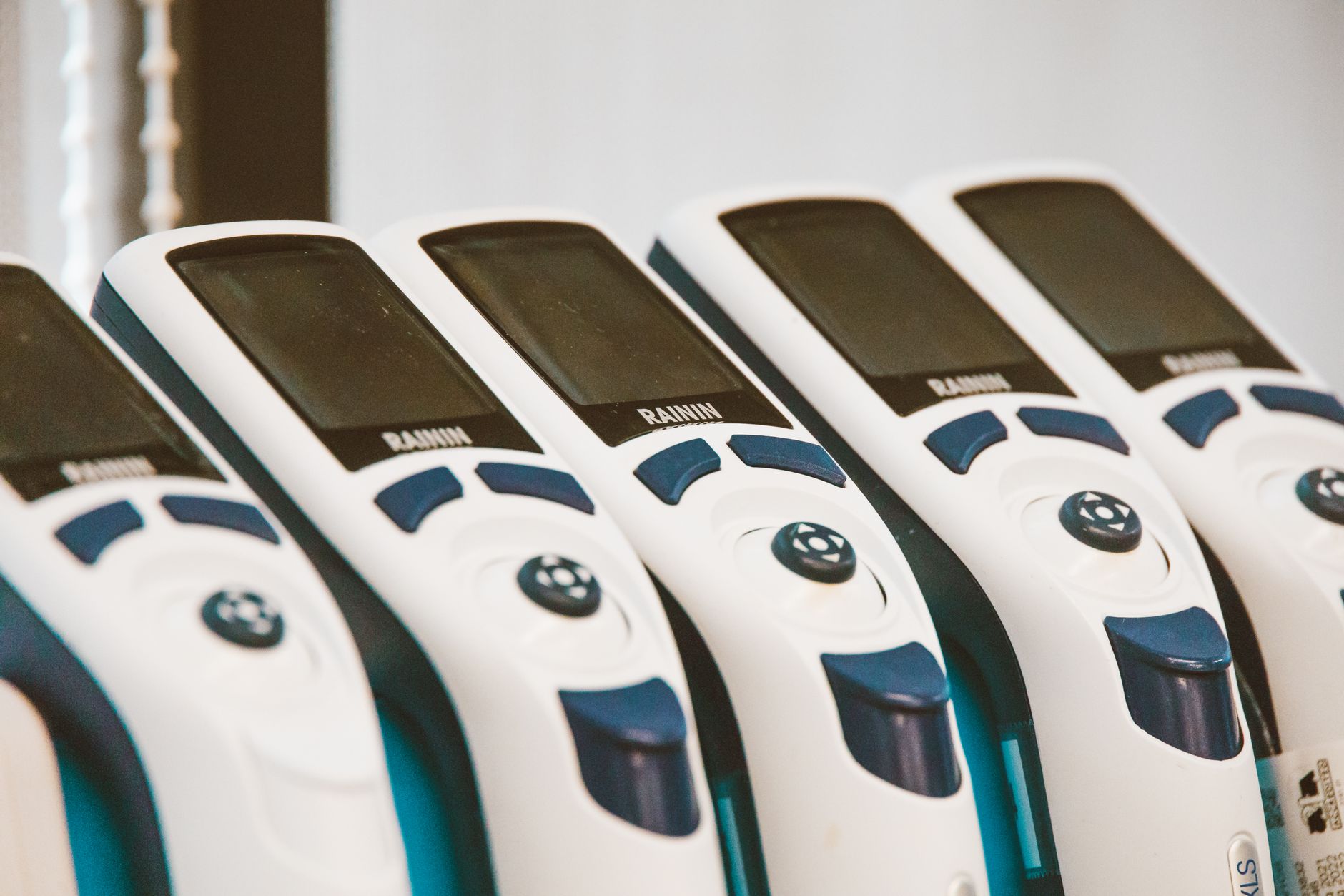 rows of ultrasound diagnostic software interfaces displayed on multiple monitors inside a hospital imaging technology lab, no people present