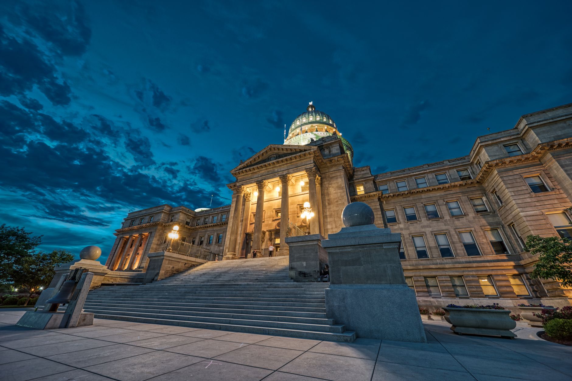 exterior facade of the United States Capitol building at dusk with amber sky visible above the dome