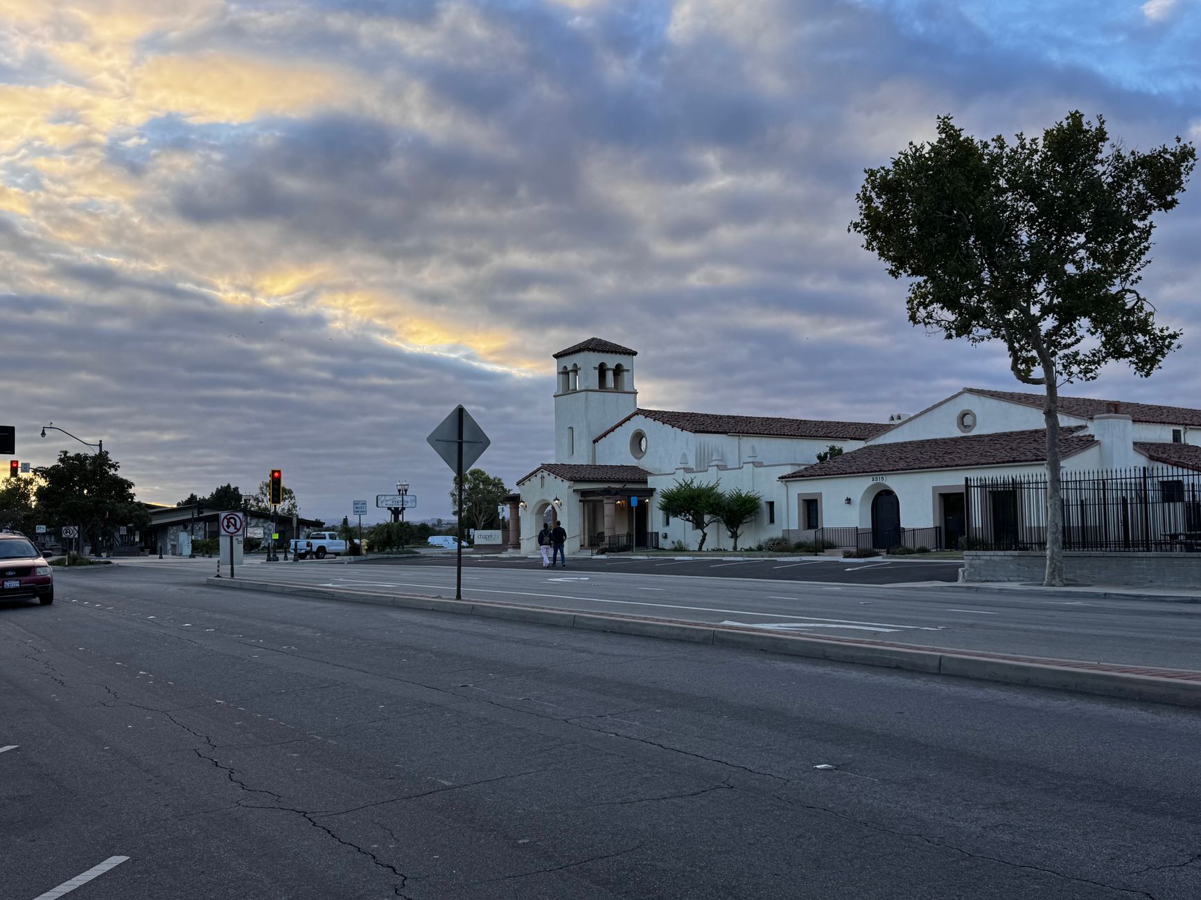 exterior of a mid-sized regional bank branch building on a quiet suburban street, early morning light, no people in foreground