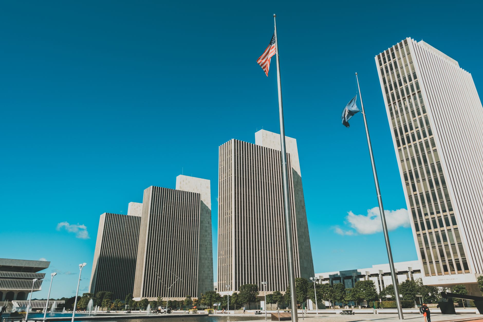 exterior of the SEC headquarters building in Washington D.C. on a clear morning, flags visible in the foreground