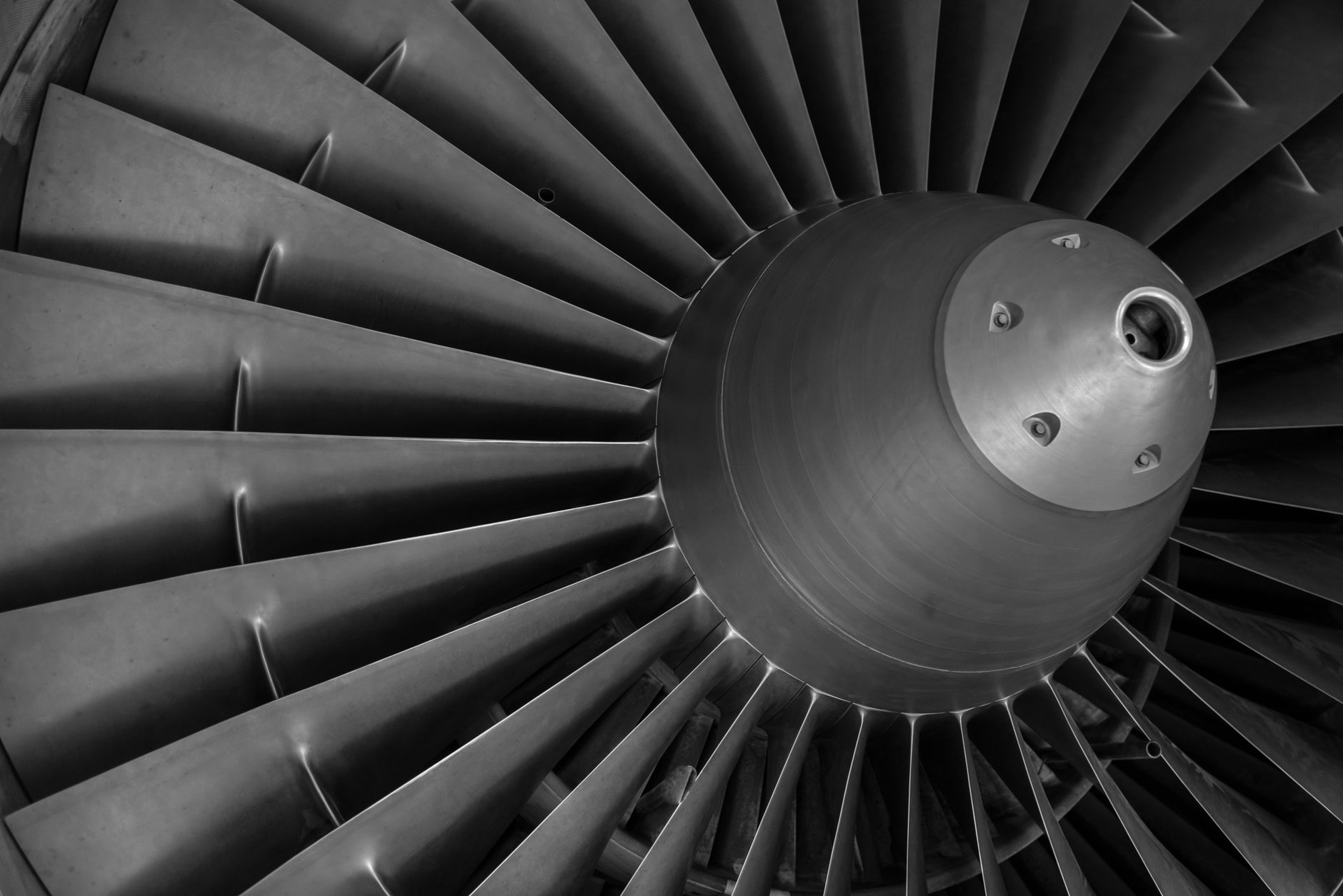 interior of an aerospace component overhaul facility with turbine housings and heat exchanger units lined up on industrial workbenches