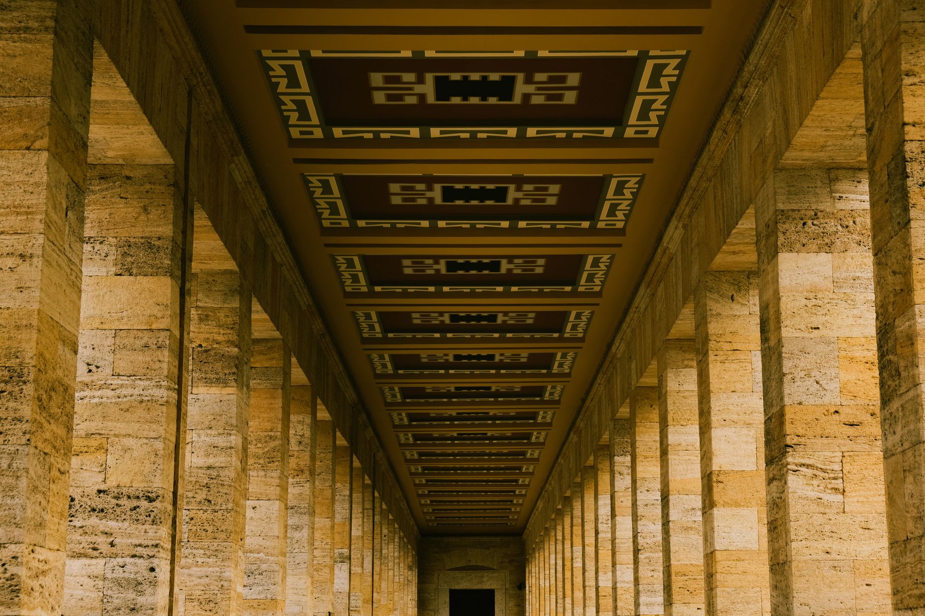 wide-angle interior of the U.S. Treasury building's ornate main corridor, empty of people, marble columns and gilt ceiling visible under institutional lighting