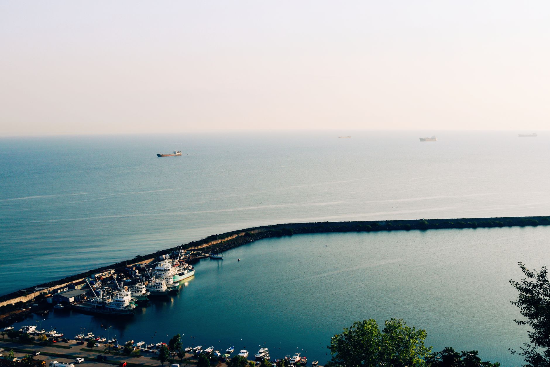 aerial view of the Strait of Hormuz showing tanker shipping lanes between arid coastlines at dawn
