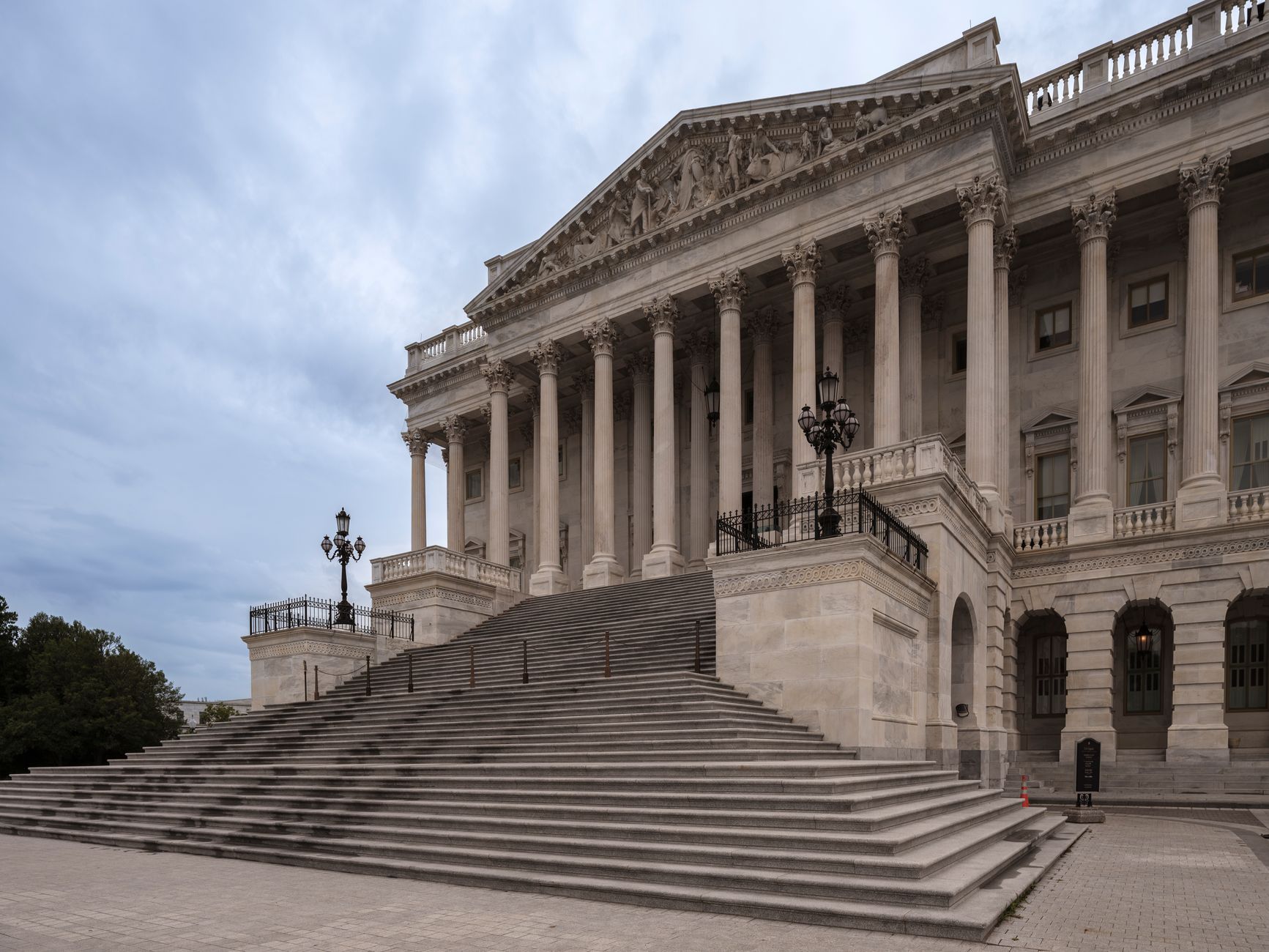 exterior of the U.S. Treasury building in Washington D.C. on an overcast morning, its neoclassical stone facade and iron fence in sharp focus