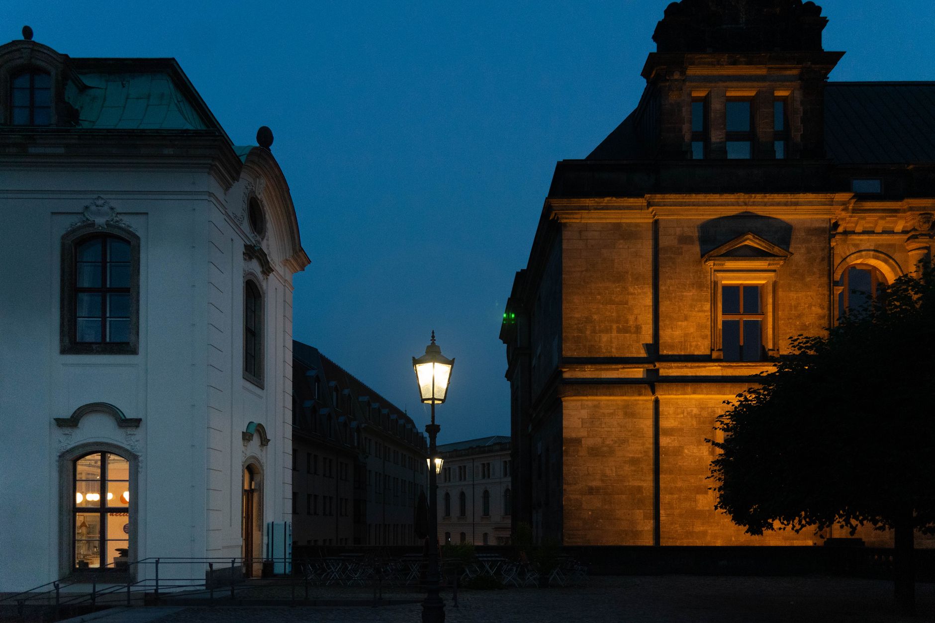 exterior of the Thuringia state parliament building in Erfurt at dusk, empty stone plaza in the foreground