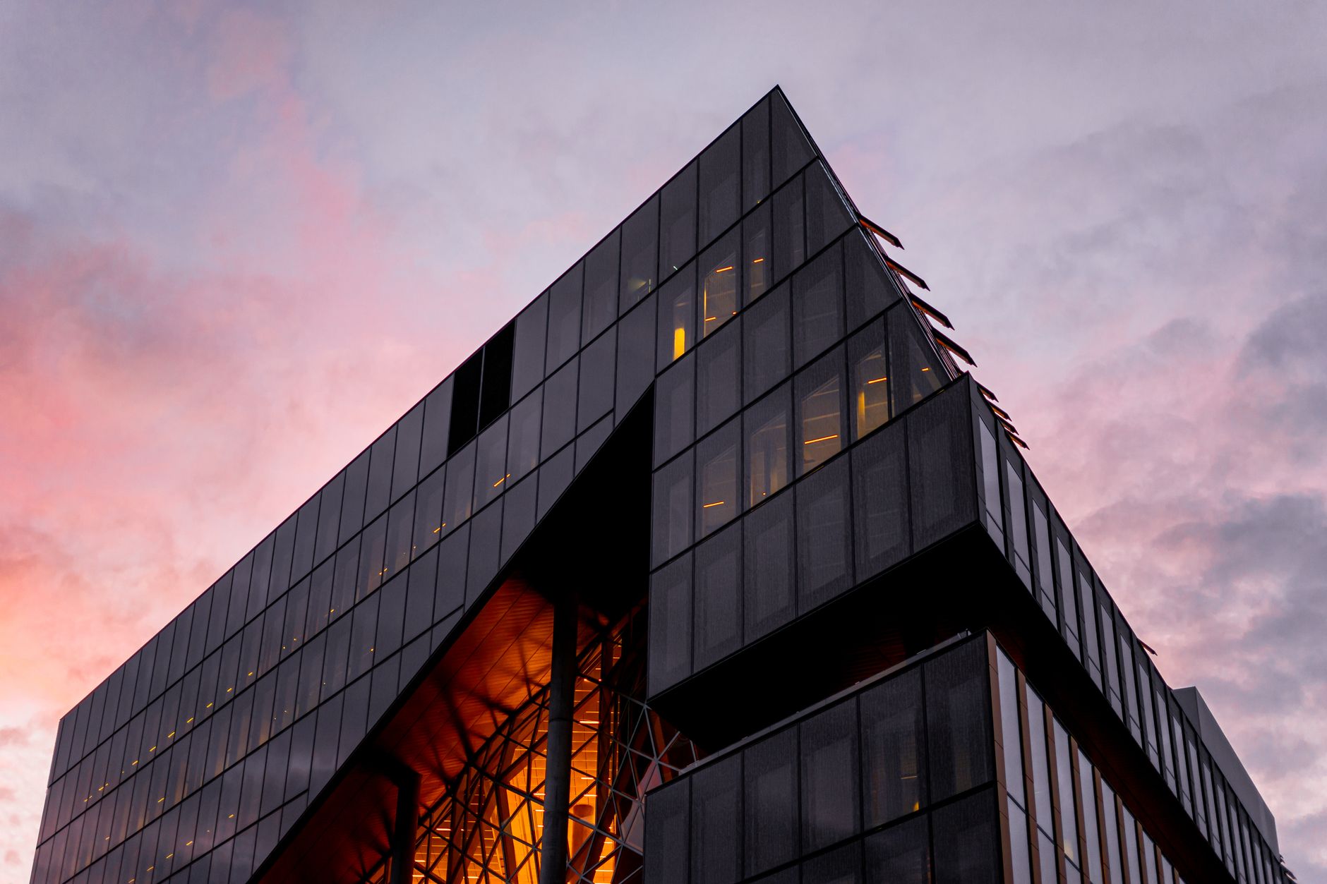 exterior view of a modern technology campus building at dusk with glass facades reflecting the evening sky