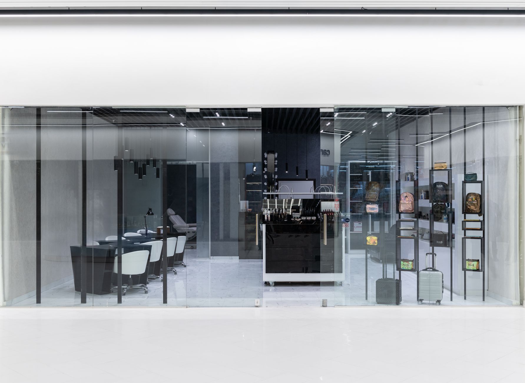 interior of a modern Japanese optical retail store with illuminated display cases showing eyewear frames and digital screens mounted on the walls