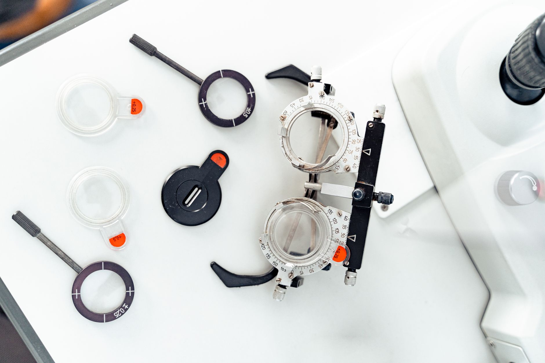 close-up of a sleek augmented reality glasses prototype resting on an optical lens testing instrument inside a laboratory setting