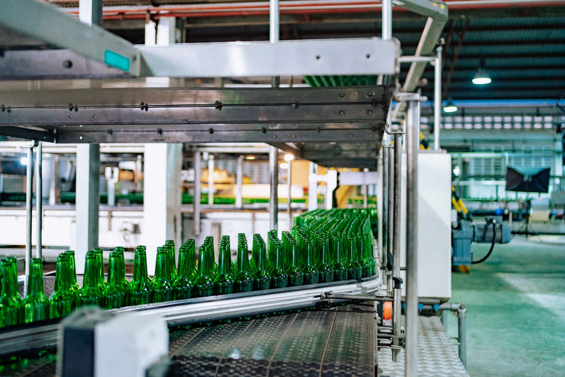 rows of industrial centrifuge machinery inside a high-security enrichment plant, viewed through a reinforced observation window