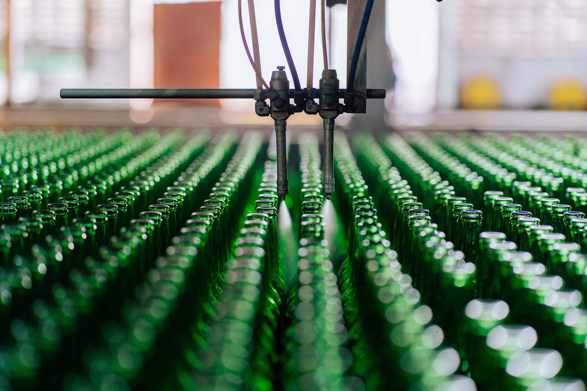 rows of precision-guided missile casings on an automated assembly line inside a modern factory floor