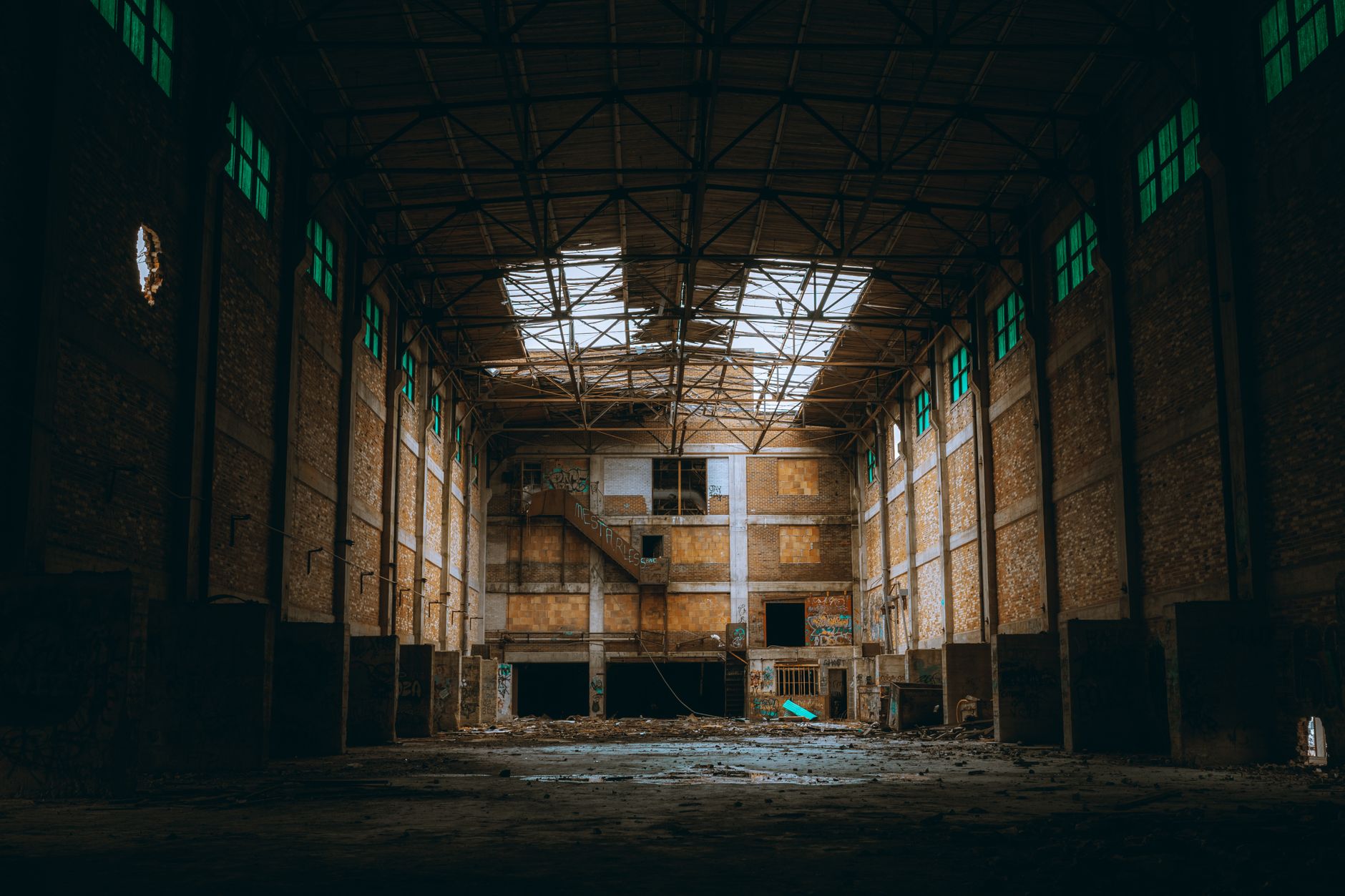 an empty factory floor with idle machinery and dusty windows in a regional English industrial building