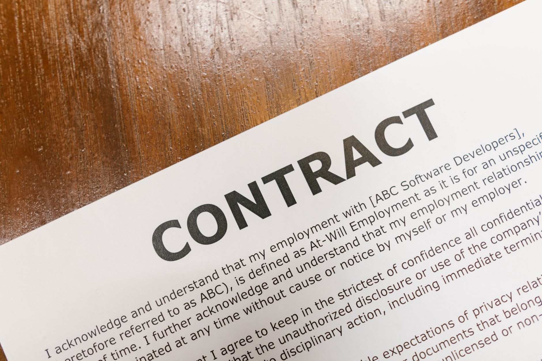 a close-up of a legal document showing equity compensation tables and strike price columns on a desk, with a pen resting across the page