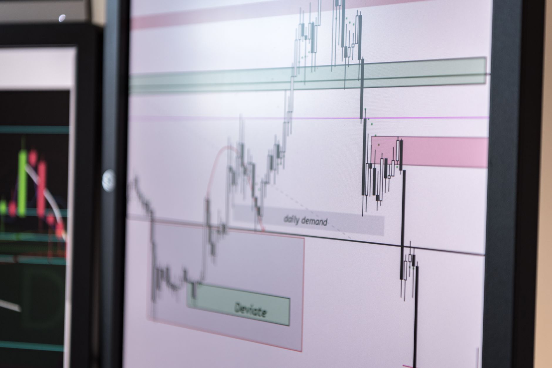 rows of fixed income trading terminals displaying U.S. Treasury yield curves and rate data on multiple monitors inside a financial trading floor, no people in foreground