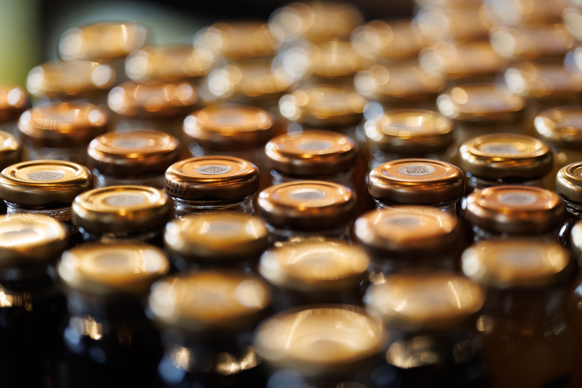 rows of gold bullion bars arranged on a vault shelf inside a secure depository facility