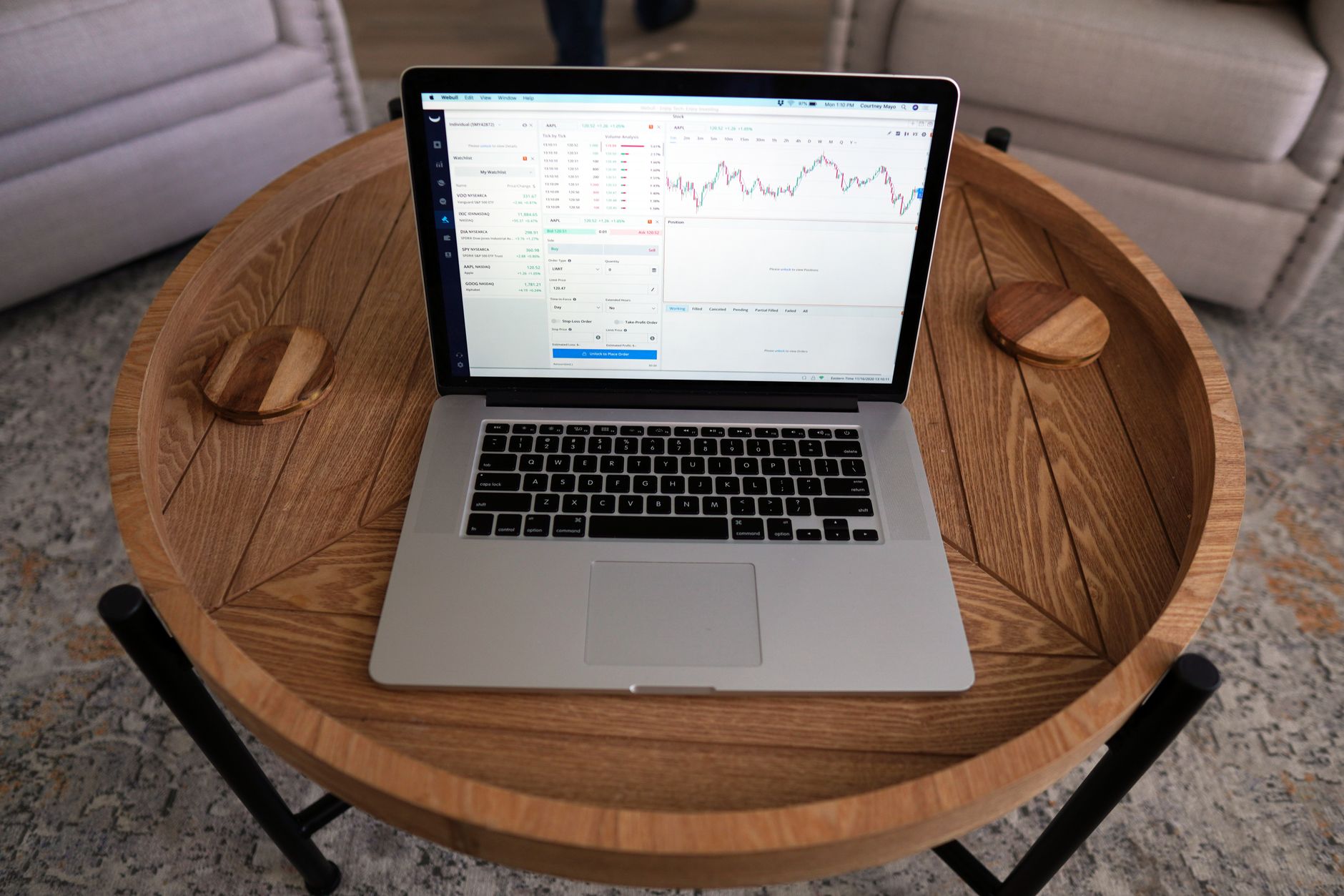 close-up of a laptop screen displaying a workforce analytics dashboard with charts showing headcount trends and performance metrics, on a clean wooden desk