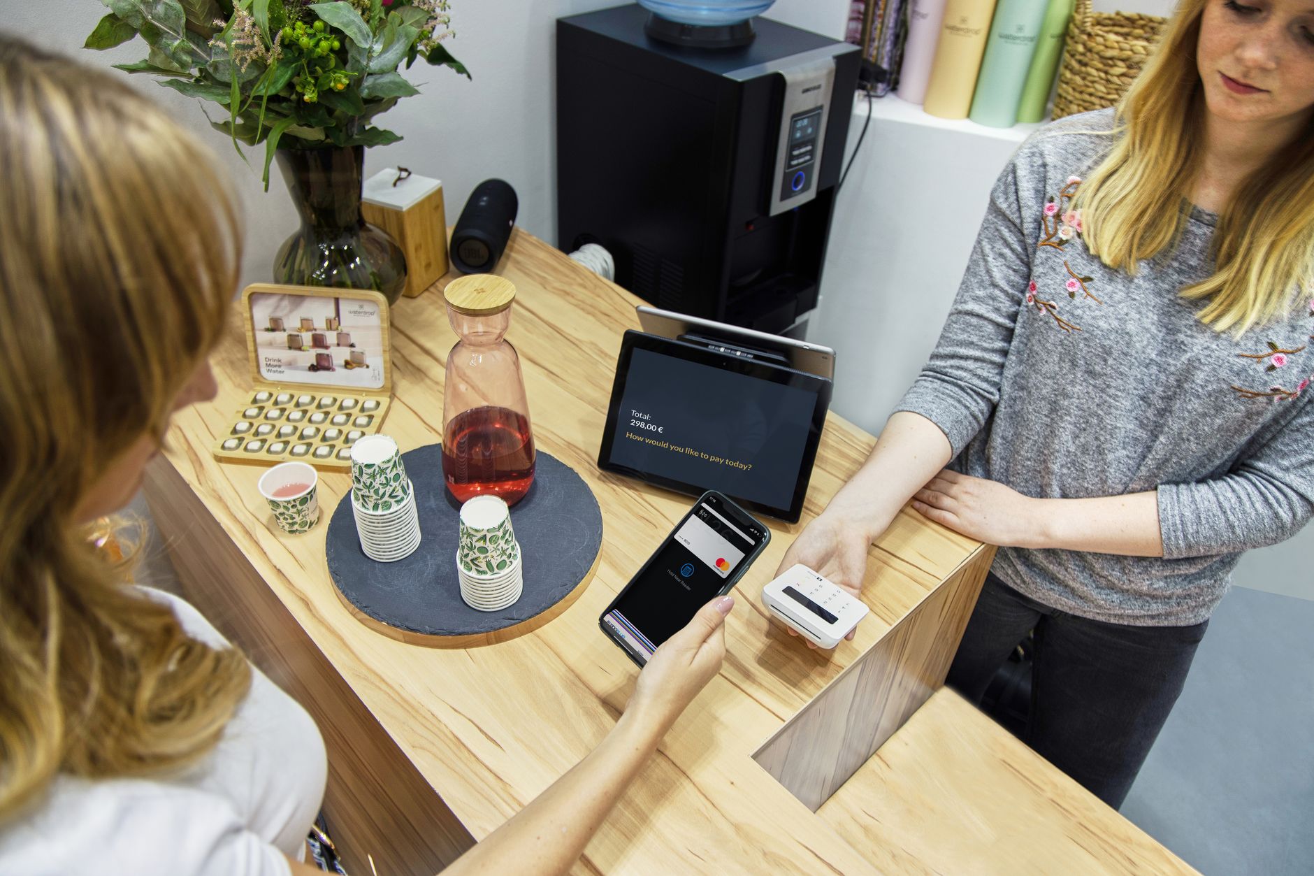 rows of digital payment terminal screens displaying UPI QR code interfaces in a retail environment