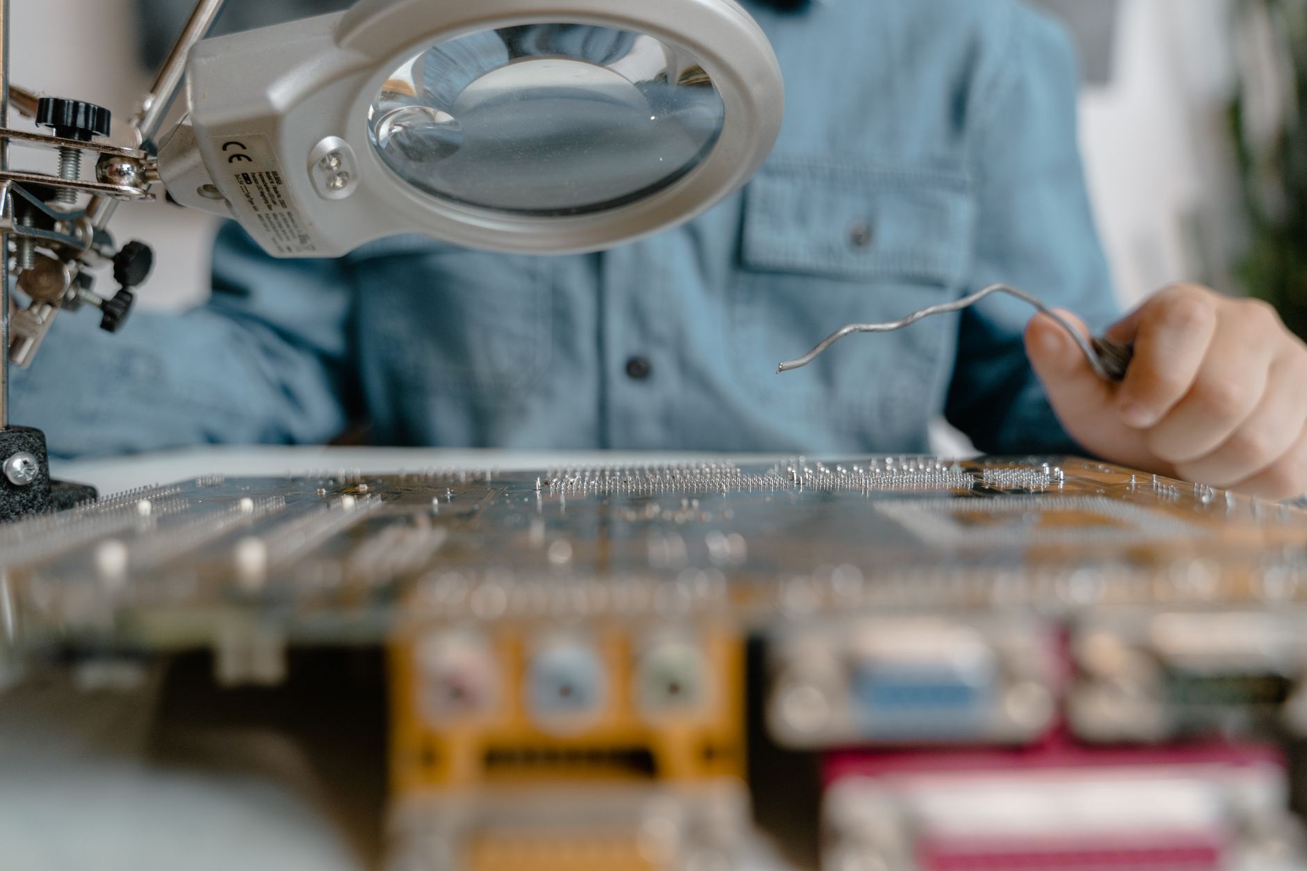 close-up of a silicon wafer with intricate circuit patterns under cleanroom laboratory lighting, resting on a precision inspection stage
