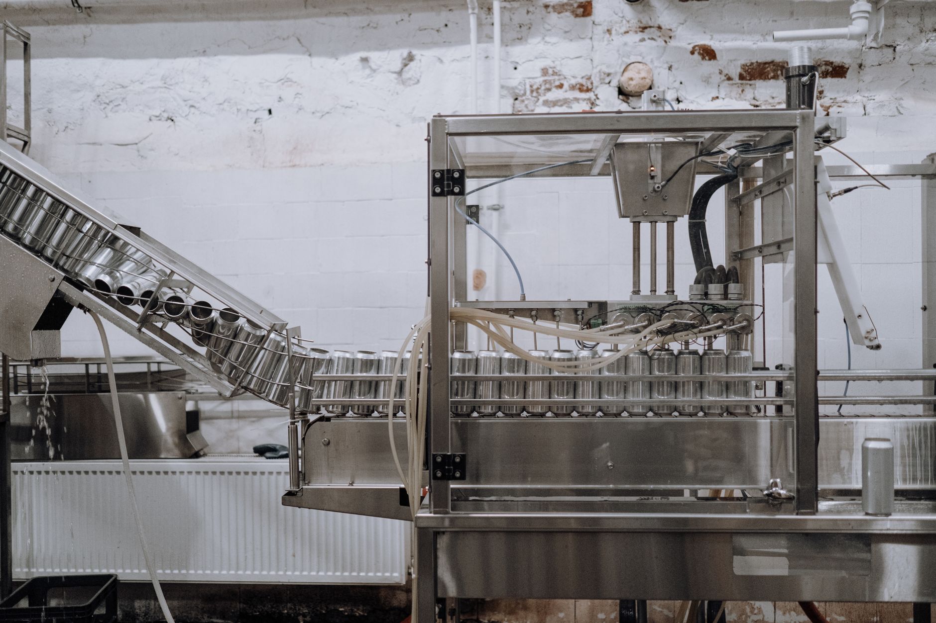 interior of a plastic packaging production line with conveyor belts carrying clear film rolls in a large industrial plant