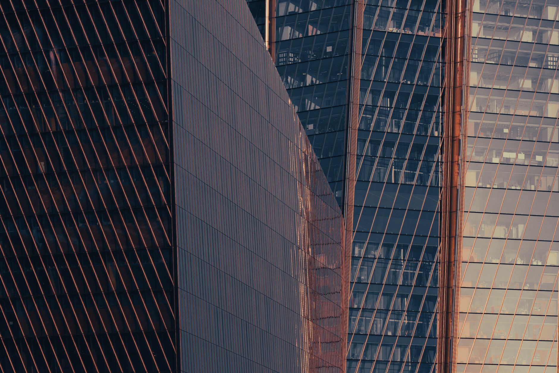 exterior of a glass-fronted financial district office tower in Singapore at dusk, with the city skyline reflected in the building's facade