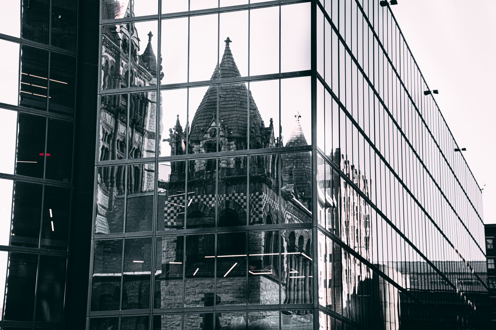 exterior of a modern law office building in lower Manhattan at dusk, glass facade reflecting city lights