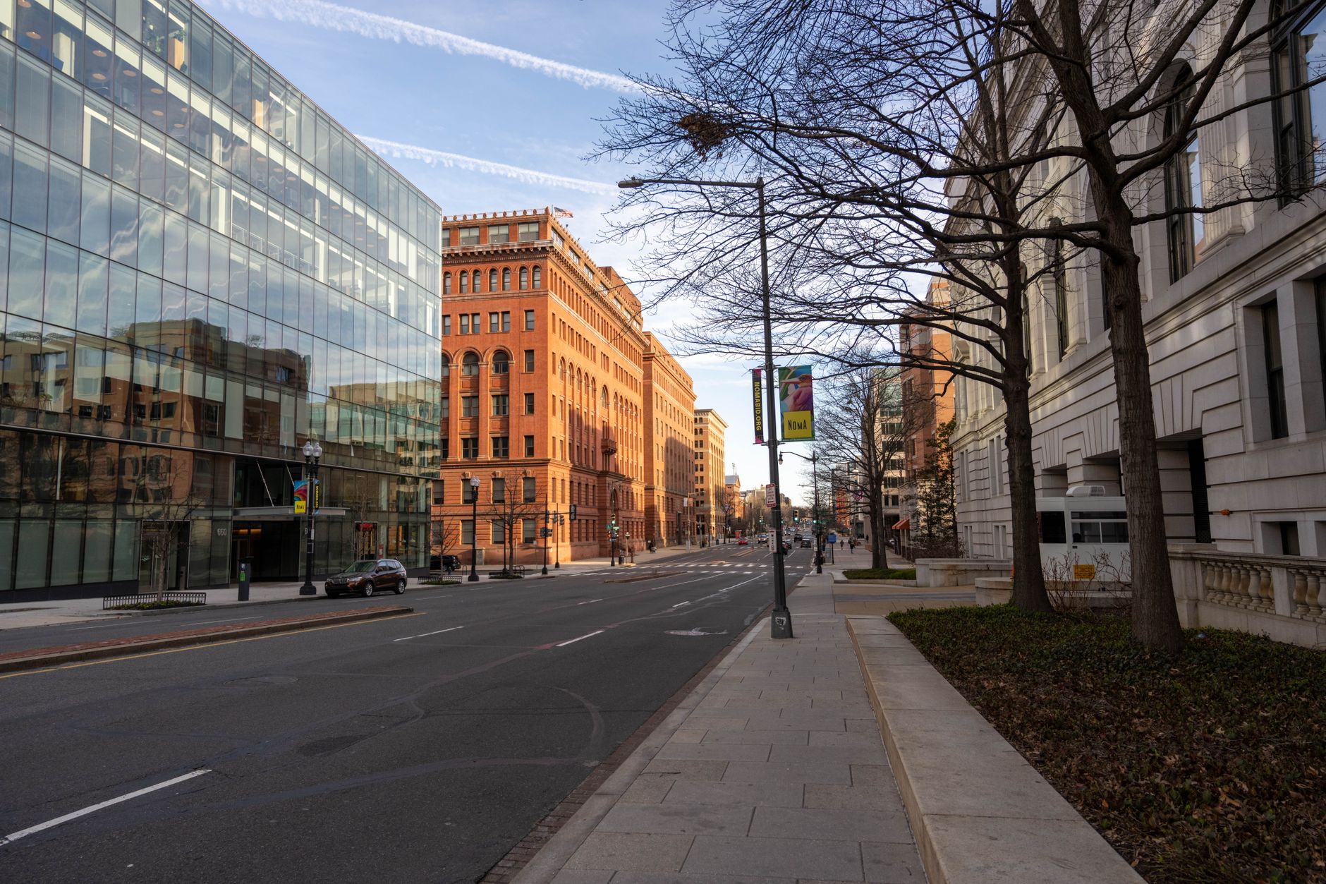 exterior of a state transportation regulatory office building on a clear morning, with a wide empty sidewalk and government signage visible above the entrance